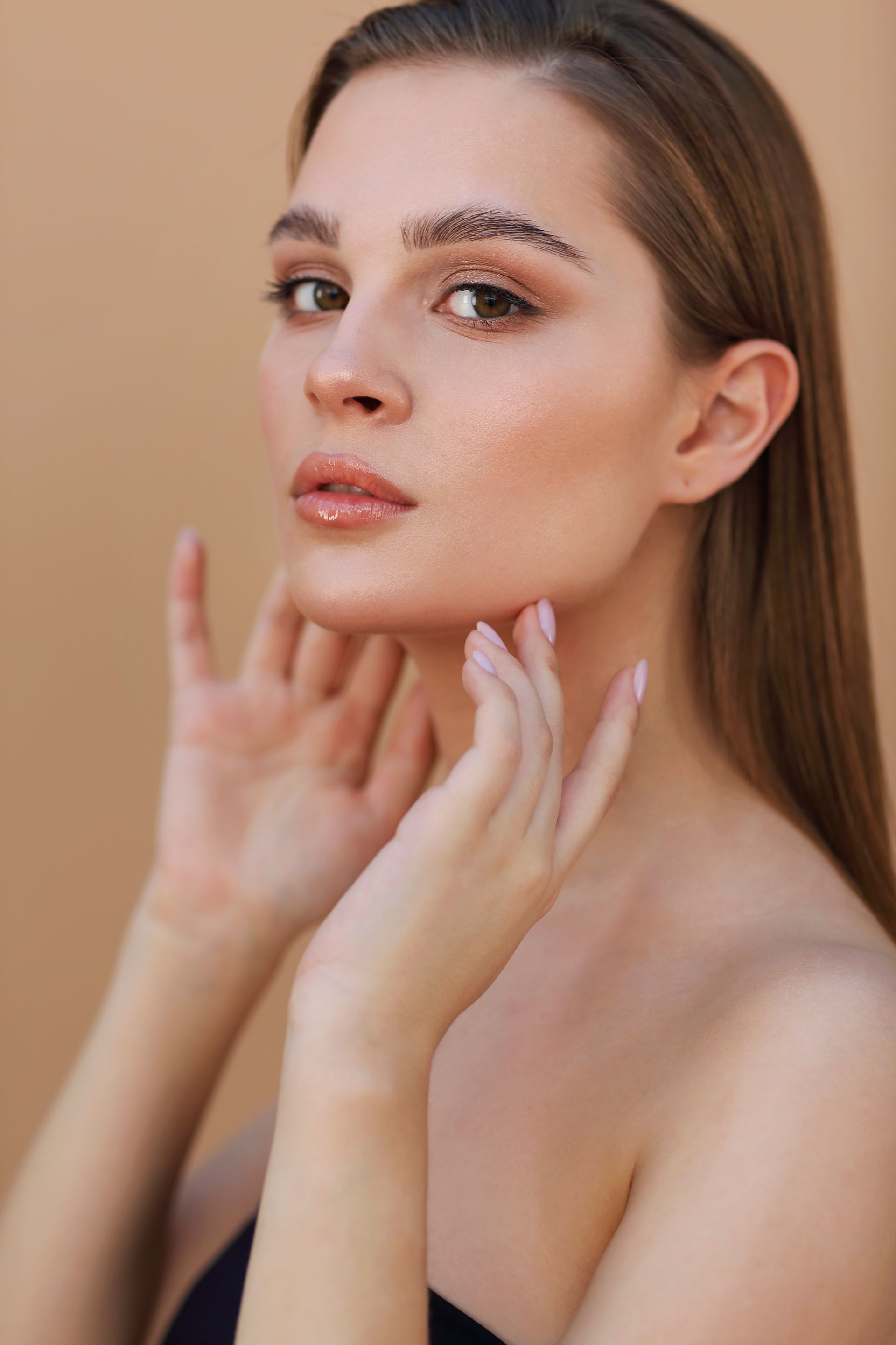 Woman with clear skin touching her jaw