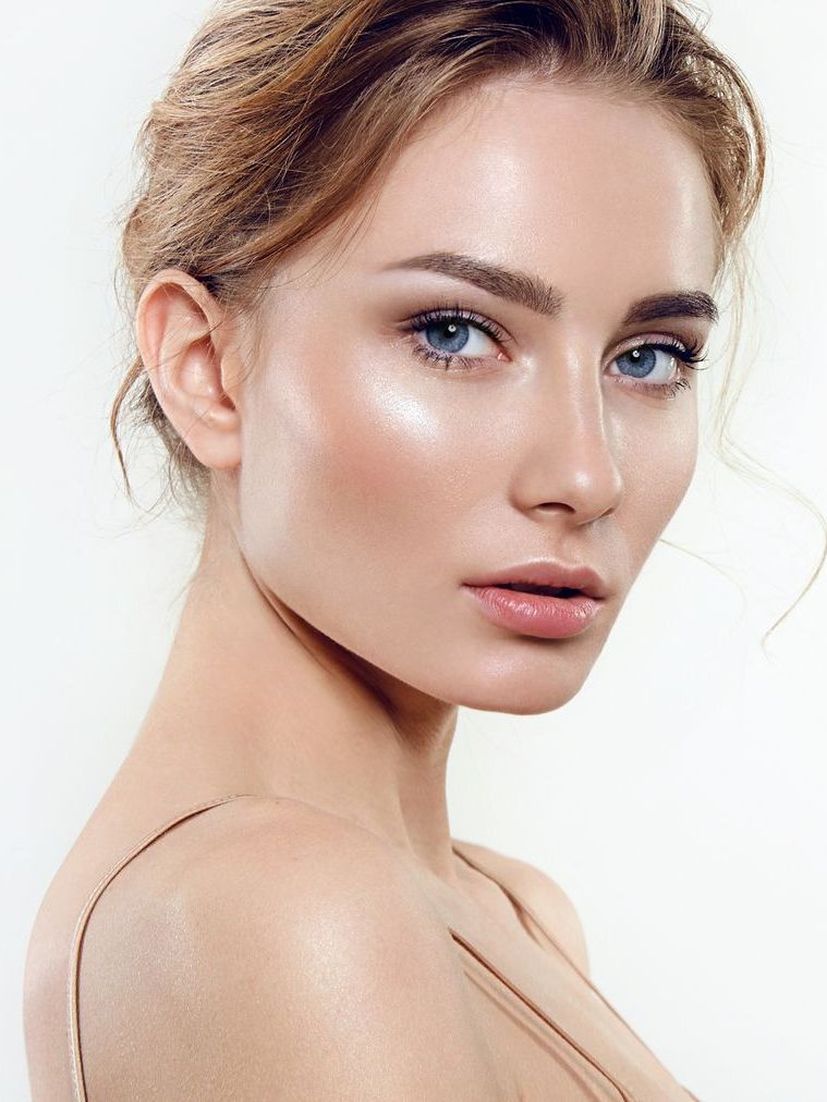 A close up of a woman 's face with no makeup on.