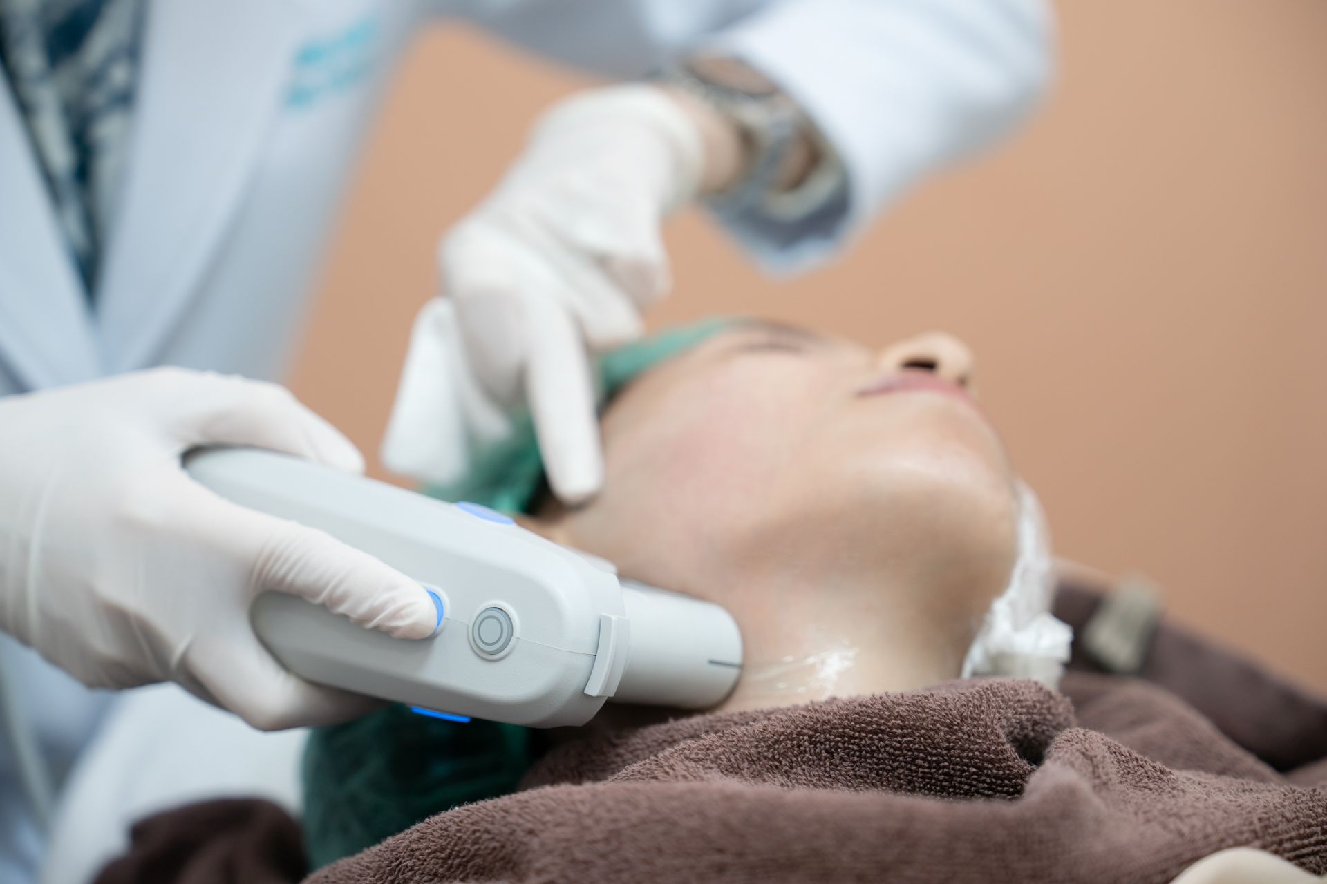 A woman is getting a facial treatment at a beauty salon.