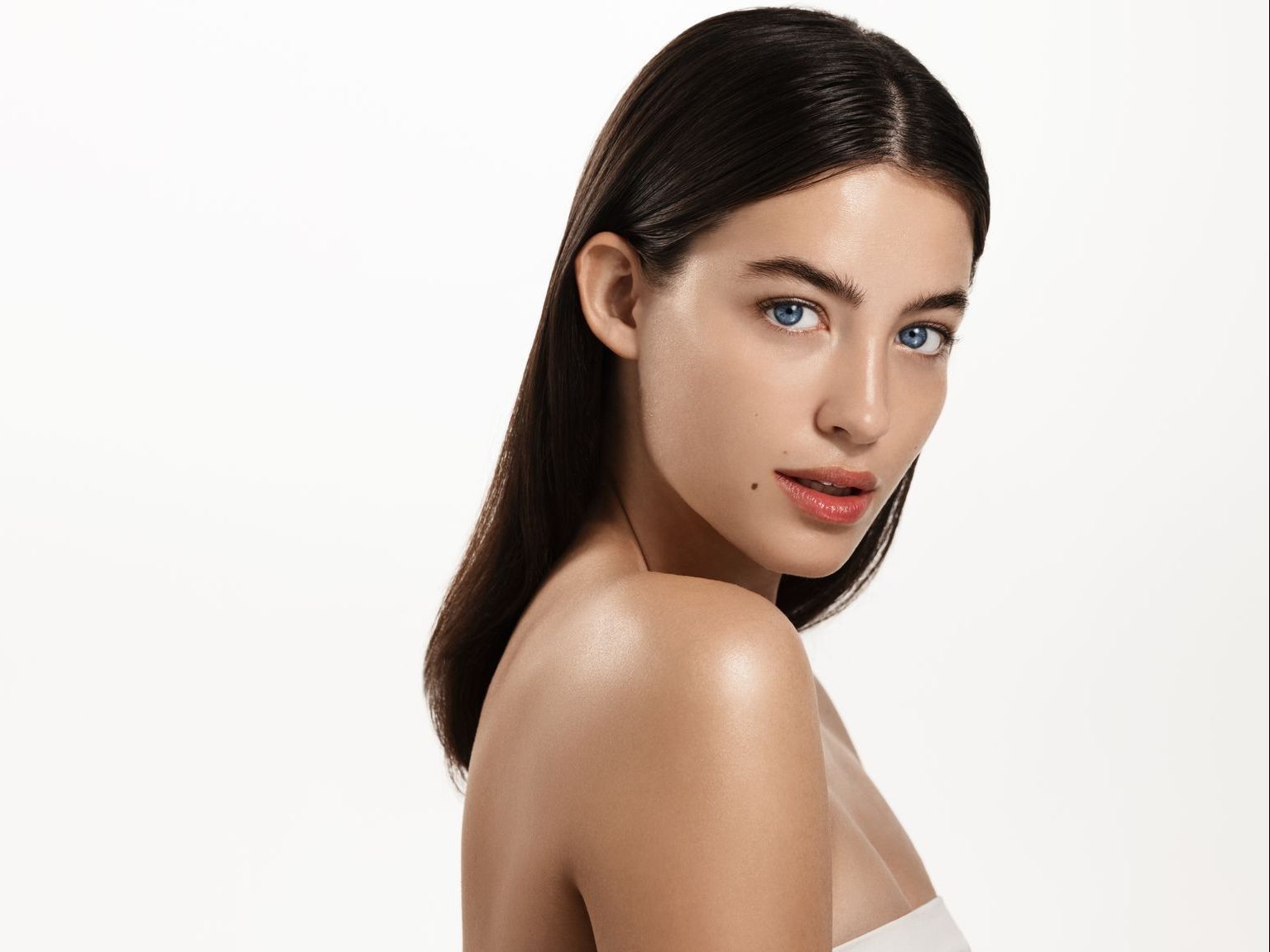 A close up of a woman 's face with a white background.