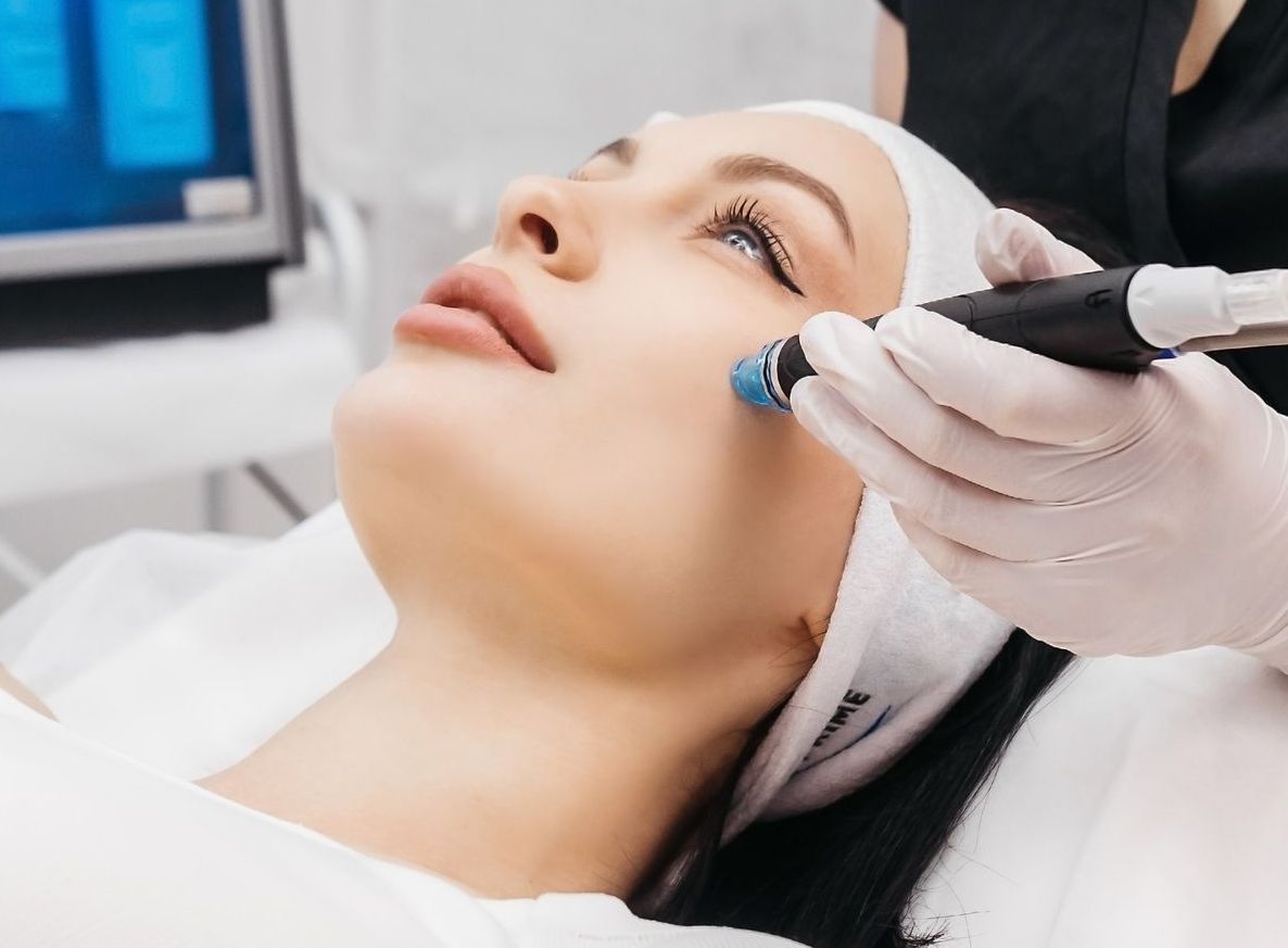 A woman is getting a facial treatment at a spa.