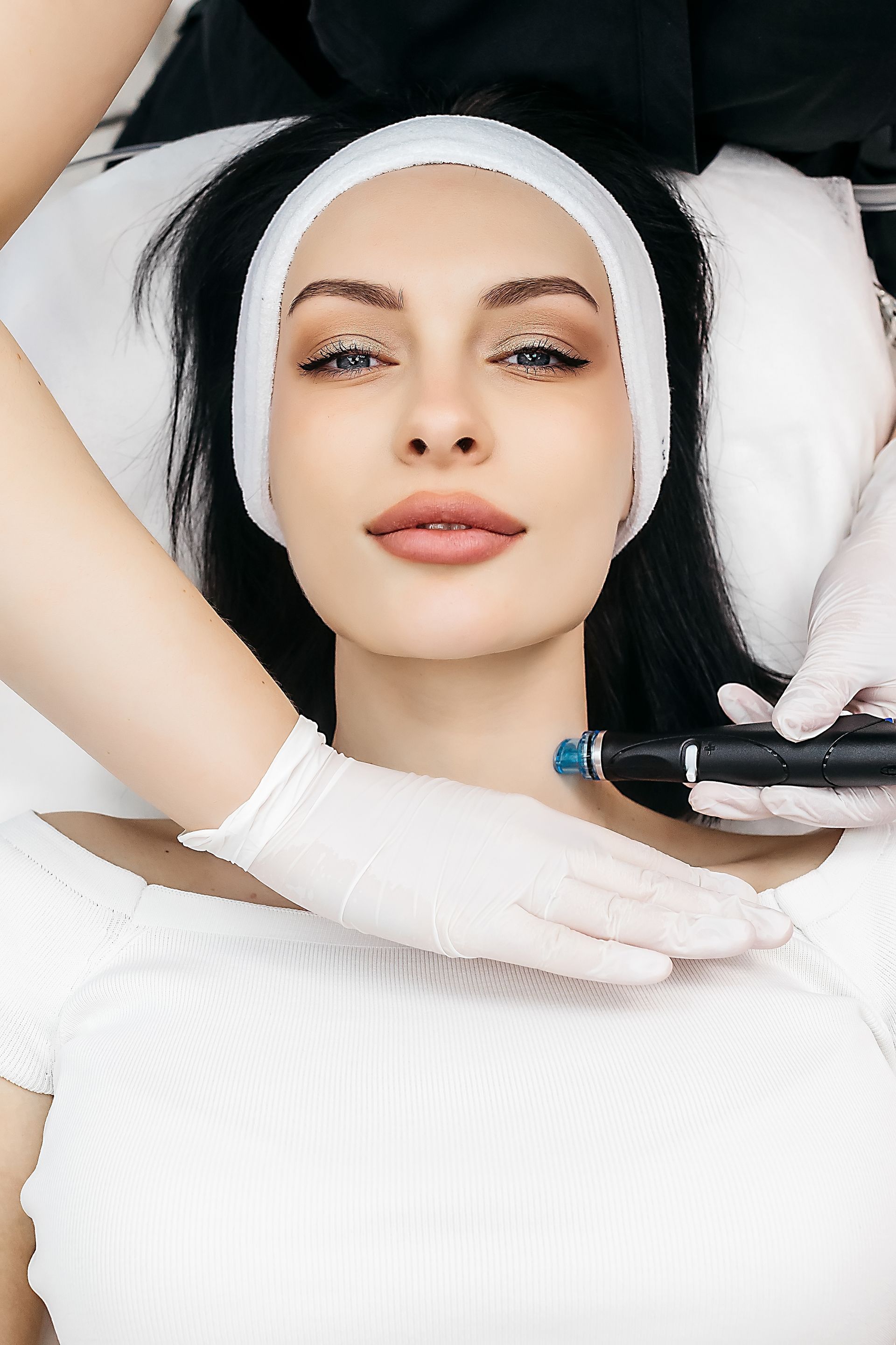 A woman is getting a facial treatment at a beauty salon.