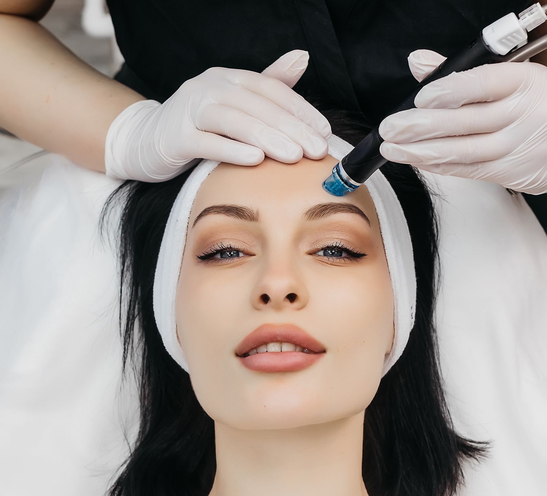 A woman is getting a treatment on her face