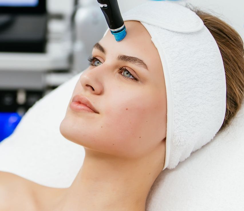 A woman is getting a facial treatment at a beauty salon.