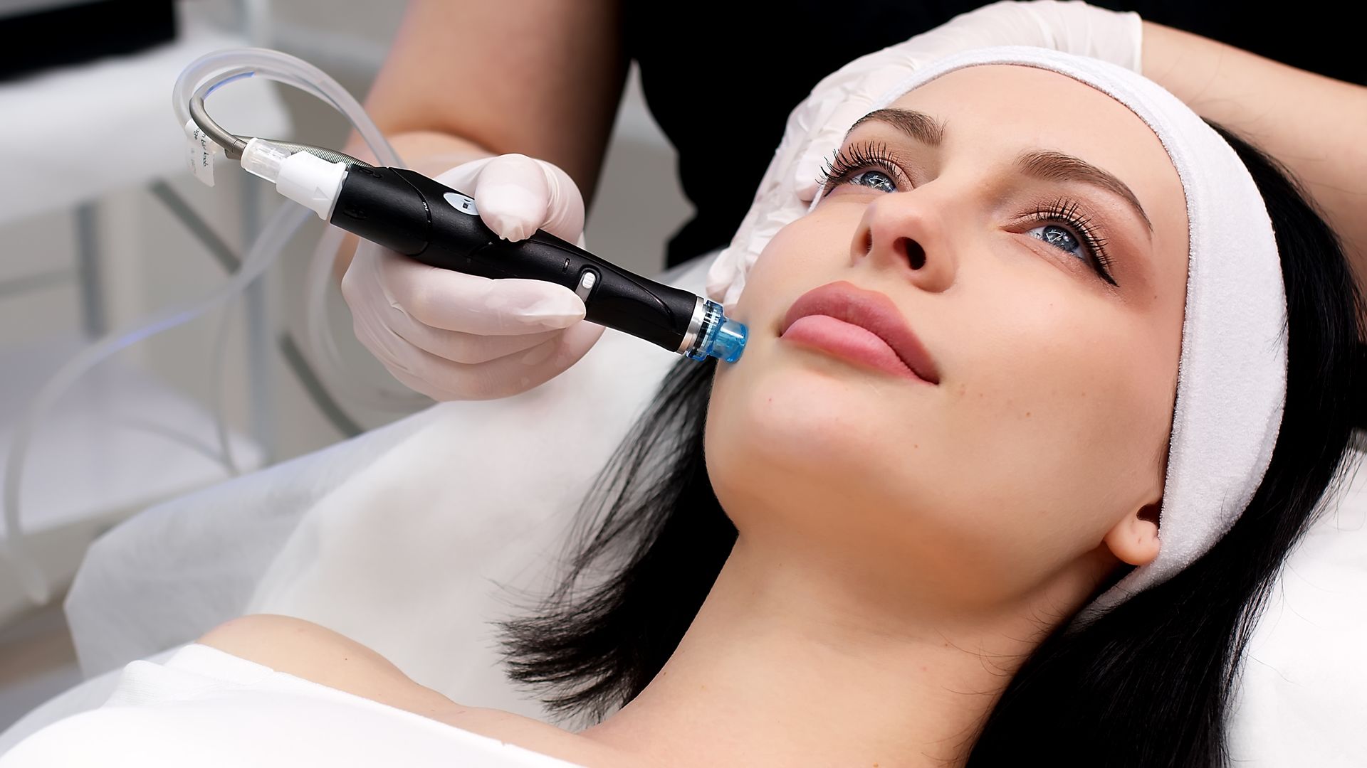 A woman is getting a facial treatment at a beauty salon.