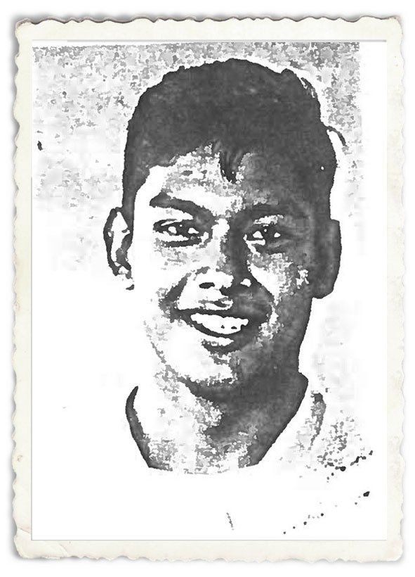 A black and white photo of a young man smiling