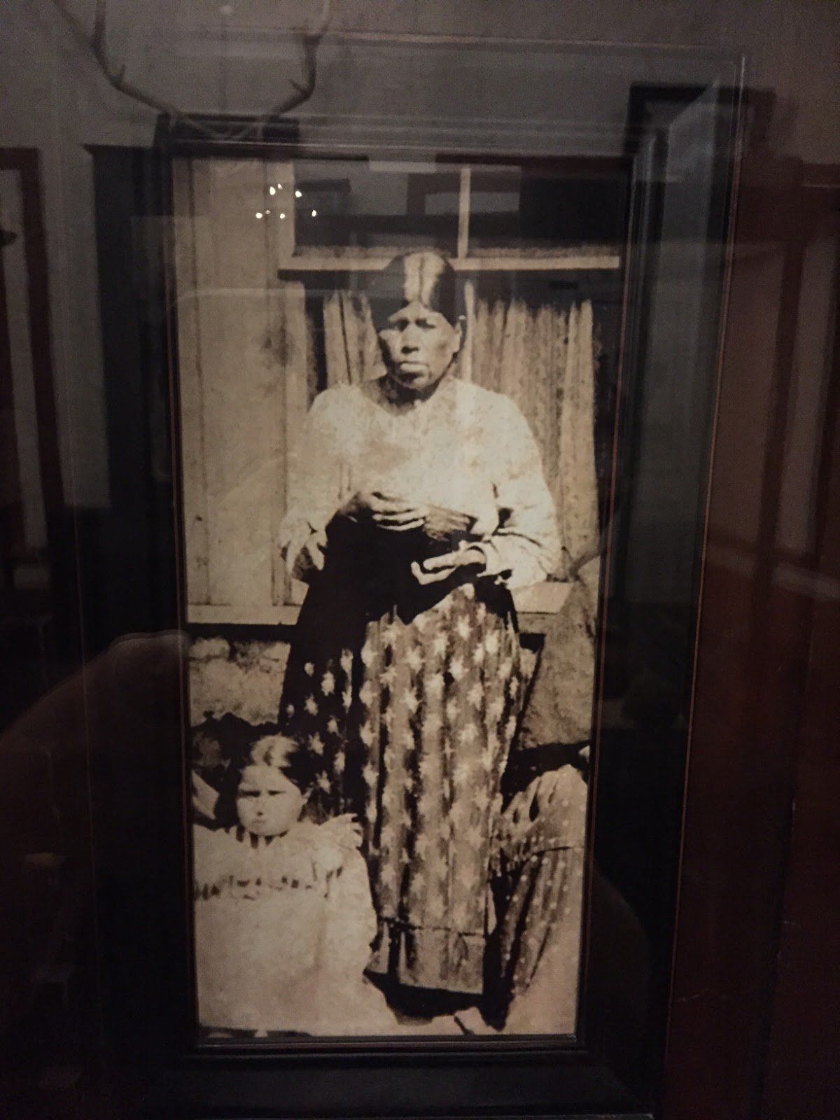 A black and white photo of a woman and two children