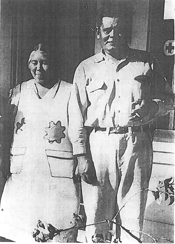 A black and white photo of a man and woman standing next to each other
