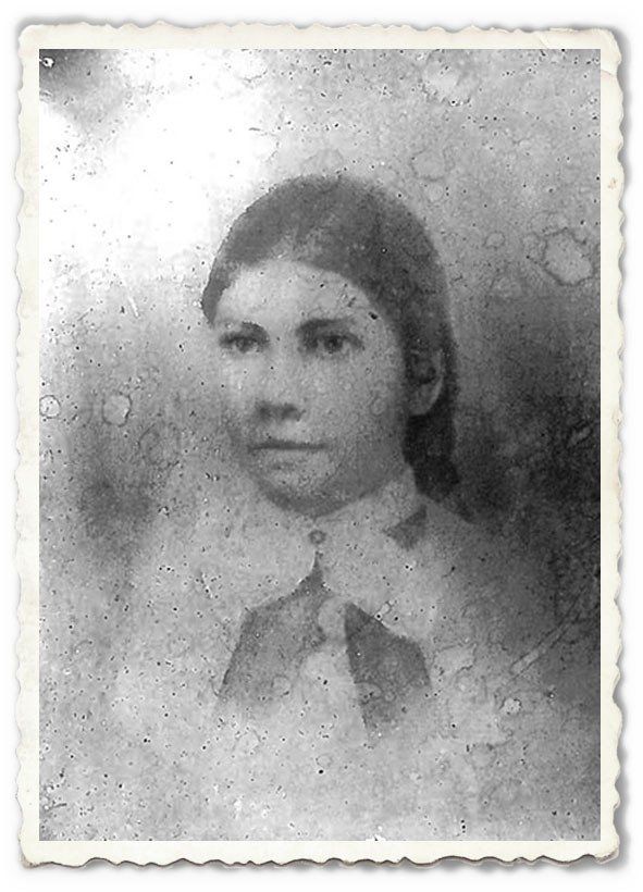 A black and white photo of a woman in a white dress and bow tie.