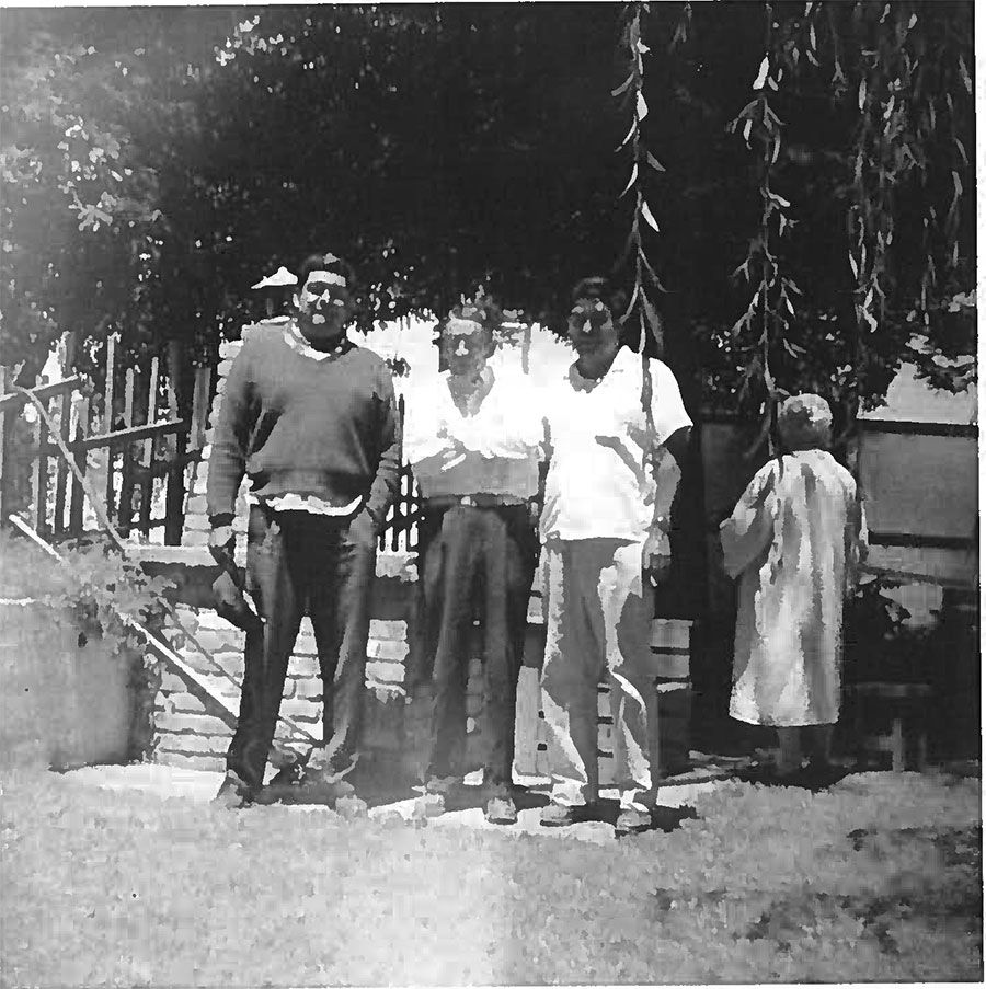A black and white photo of three people posing for a picture