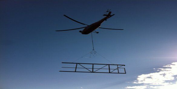 Helicopter carrying fence like object — Little Rock, AR — BM Mechanical Corp. Inc.