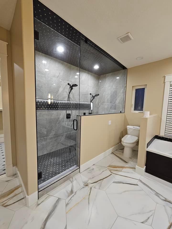 A bathroom with a walk in shower and a toilet.