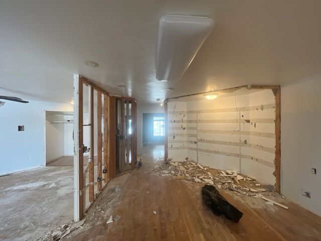 An empty room with a vacuum cleaner on the floor