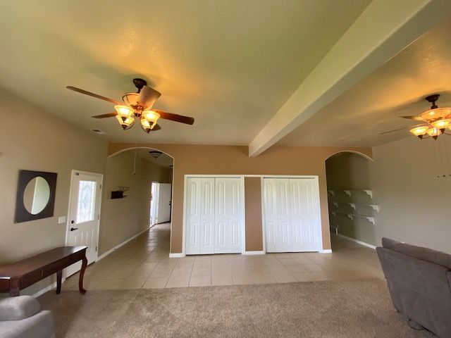 A living room with a ceiling fan and a couch