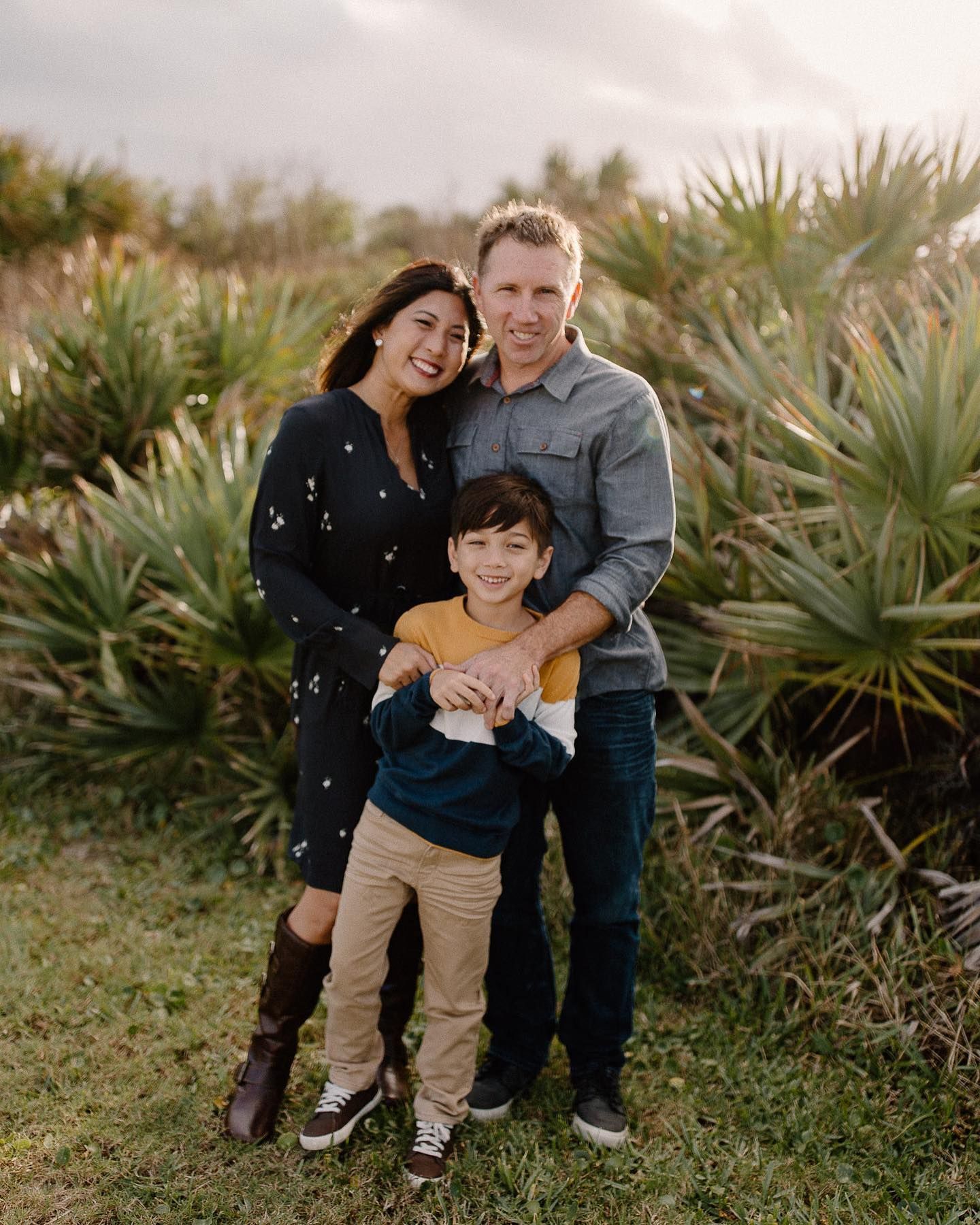 Modern office setup with a long white desk, chairs, and privacy screens.