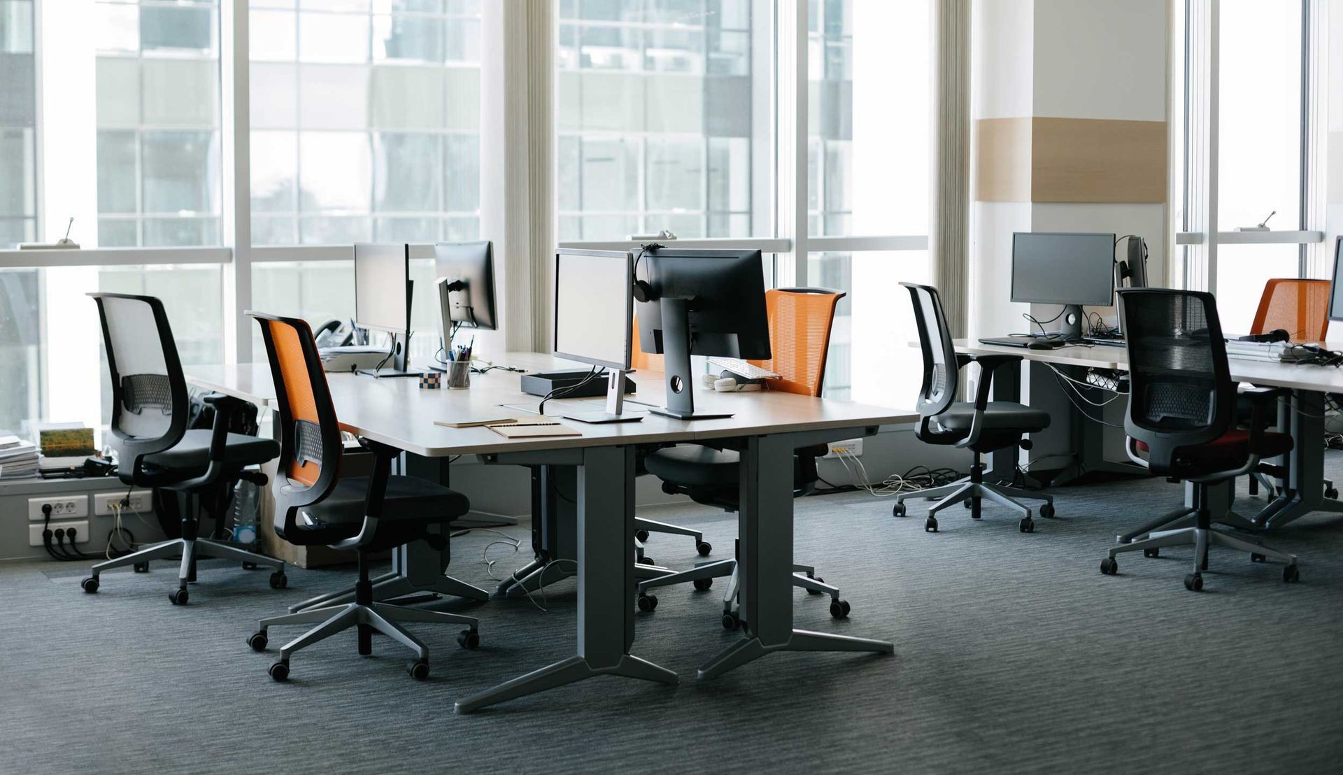 Office interior highlighting new office benching systems with ergonomic chairs for productivity.
