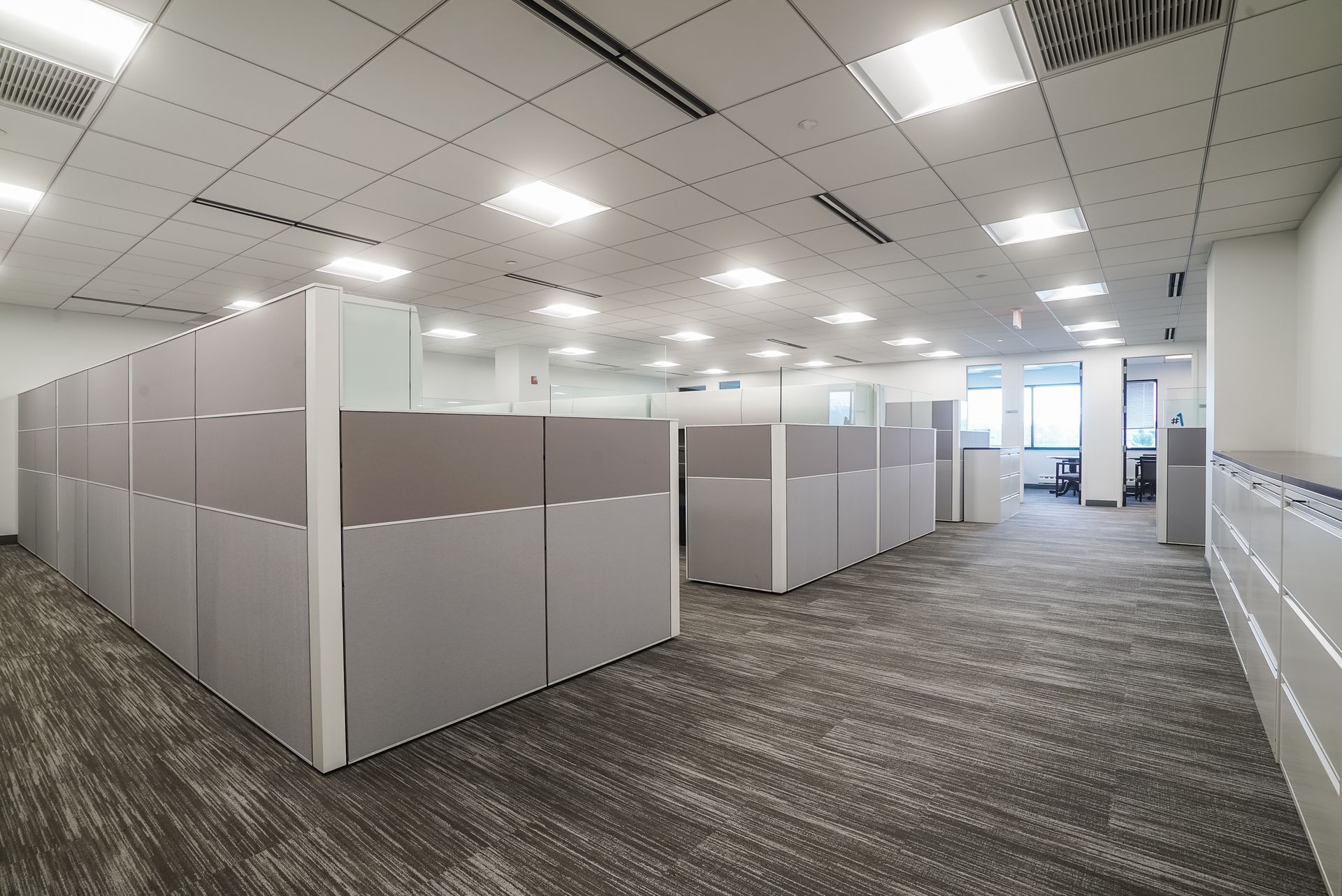 Corporate office space with a row of cubicles.
