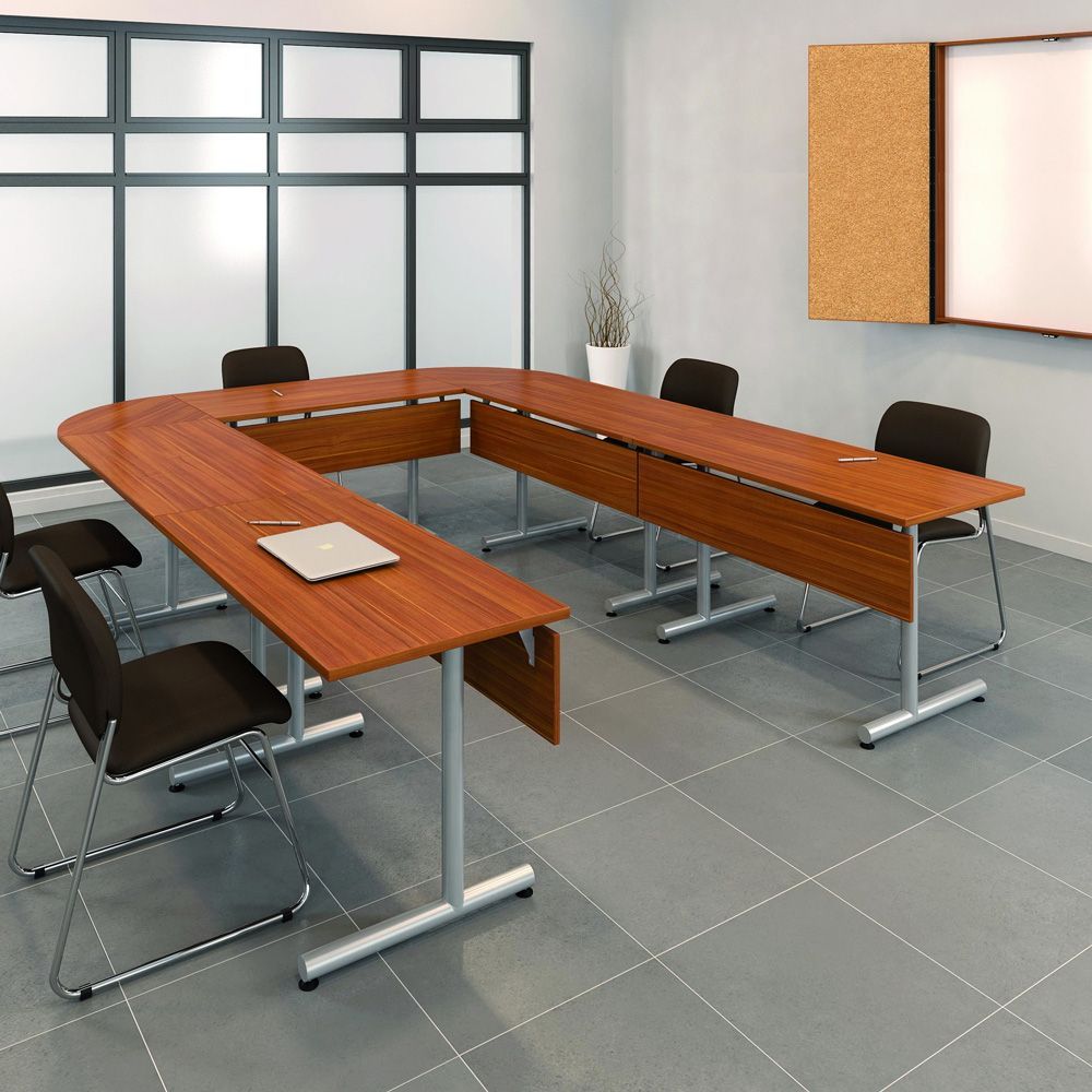 A U-shaped conference table with chairs in an office setting.