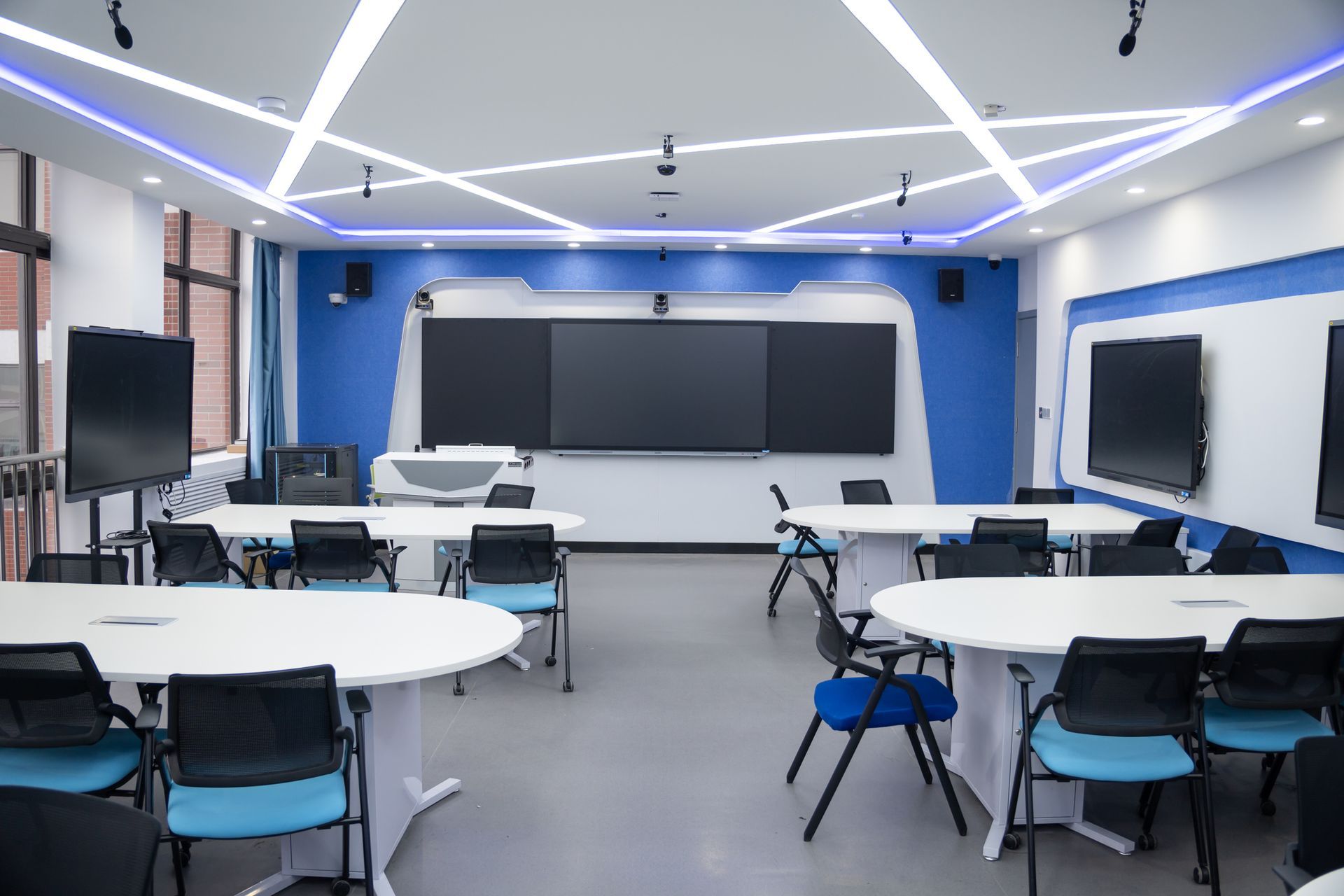 Office space with exposed beams, workstations, and wood flooring; a blueprint-like effect.