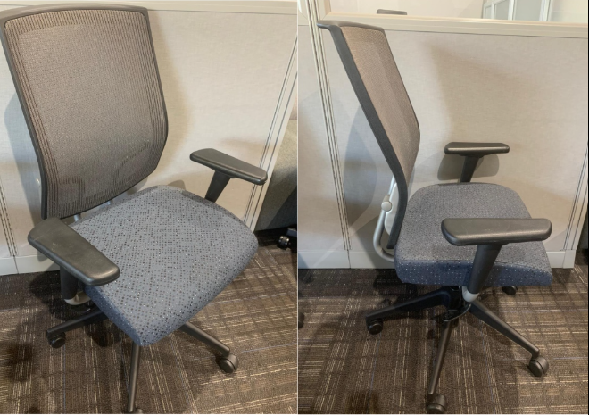 Office cubicles with desks, computers, and chairs. Beige and blue partitions with a blue wall.