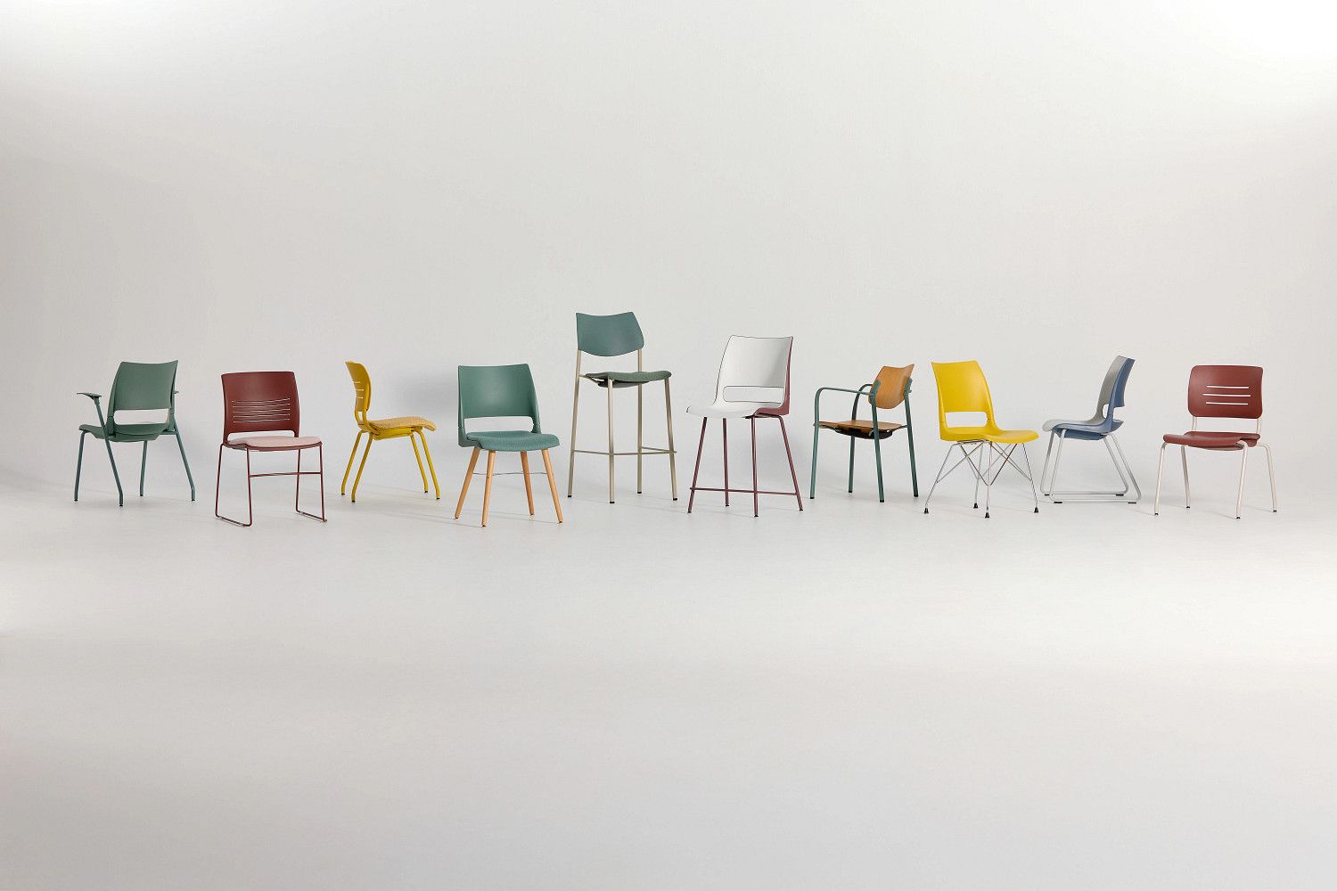 Assortment of colorful chairs of different designs on a white background.