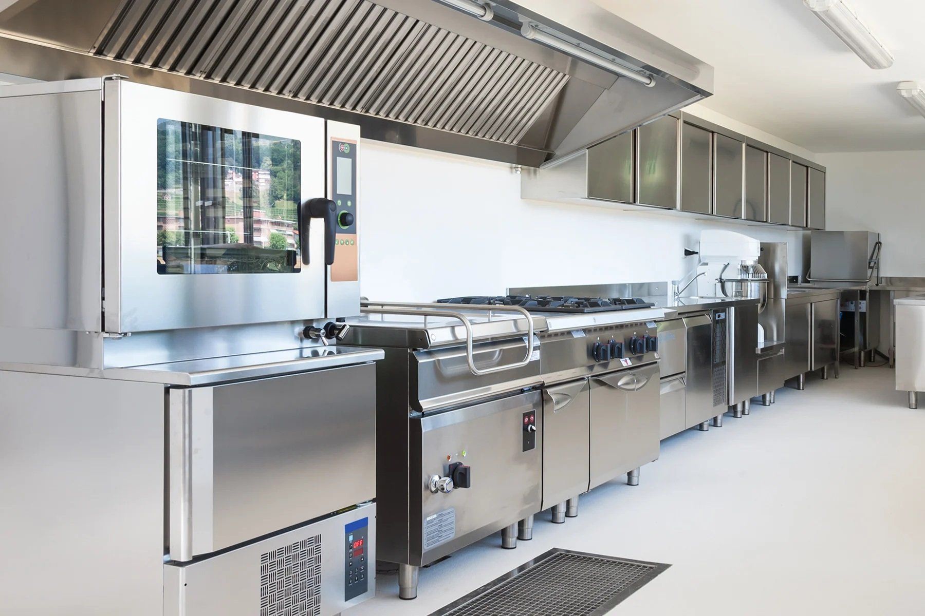 A modern commercial stainless steel kitchen with professional-grade appliances and sleek design.