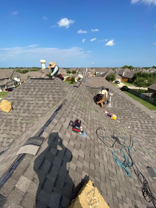 A group of people are working on a roof.