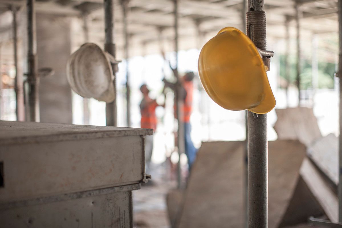 Hard Hats & Two Construction Workers in the Back. PCE Construction Values Safe Mid-MO Construction