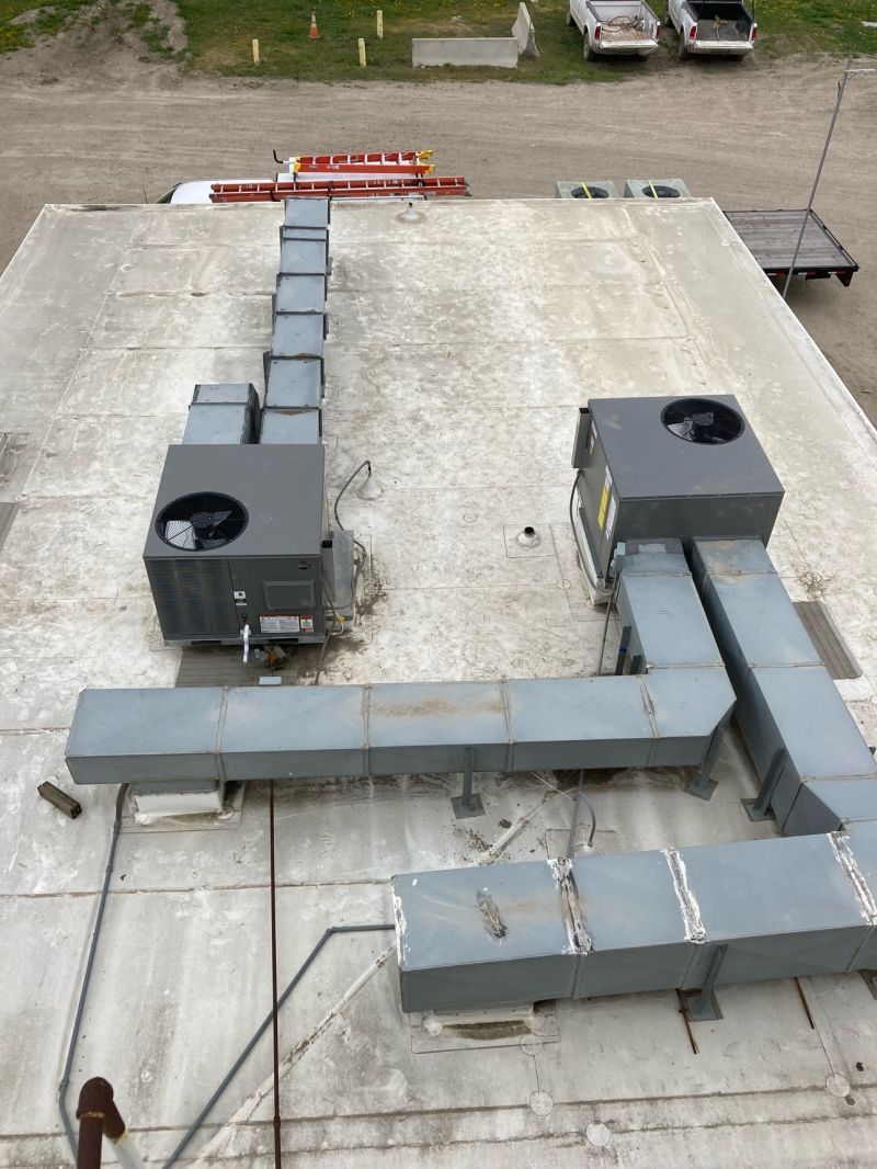 An aerial view of a roof with a lot of ducts on it.