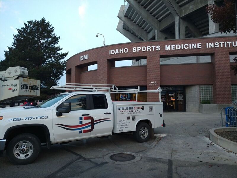 A white truck is parked in front of the idaho sports medicine institute