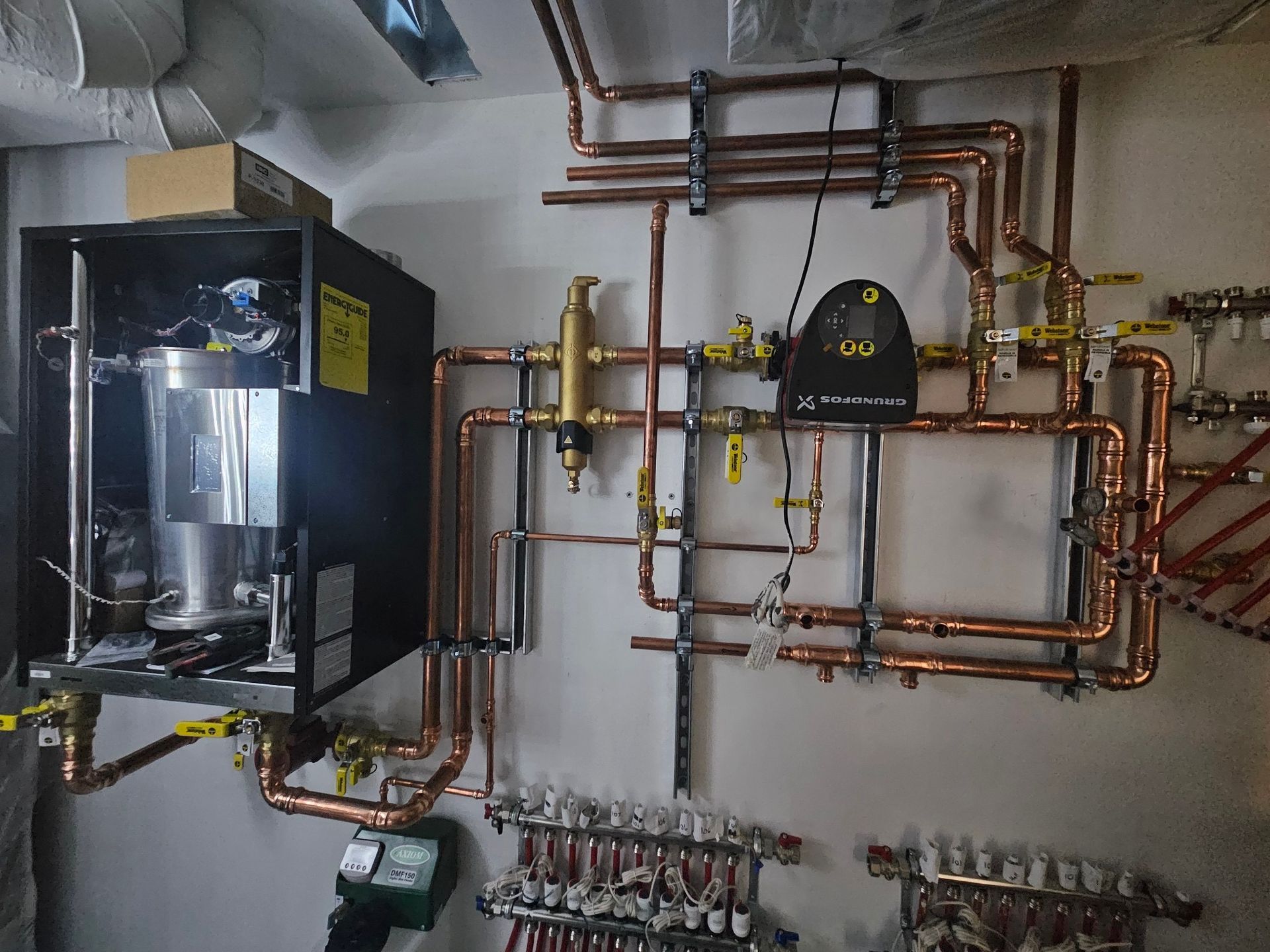 A room with a lot of copper pipes hanging on the wall.