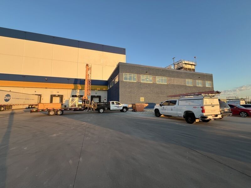 A large building with trucks parked in front of it