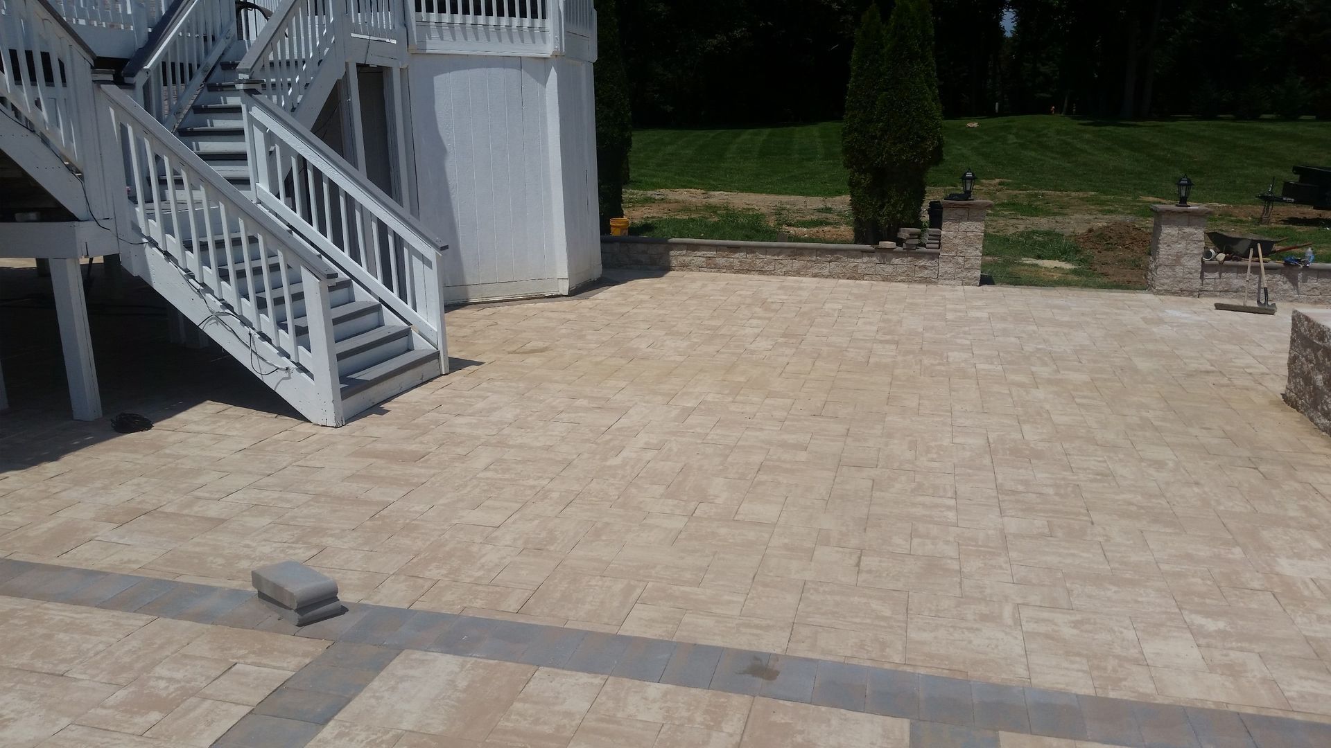 A patio with stairs leading up to a house.