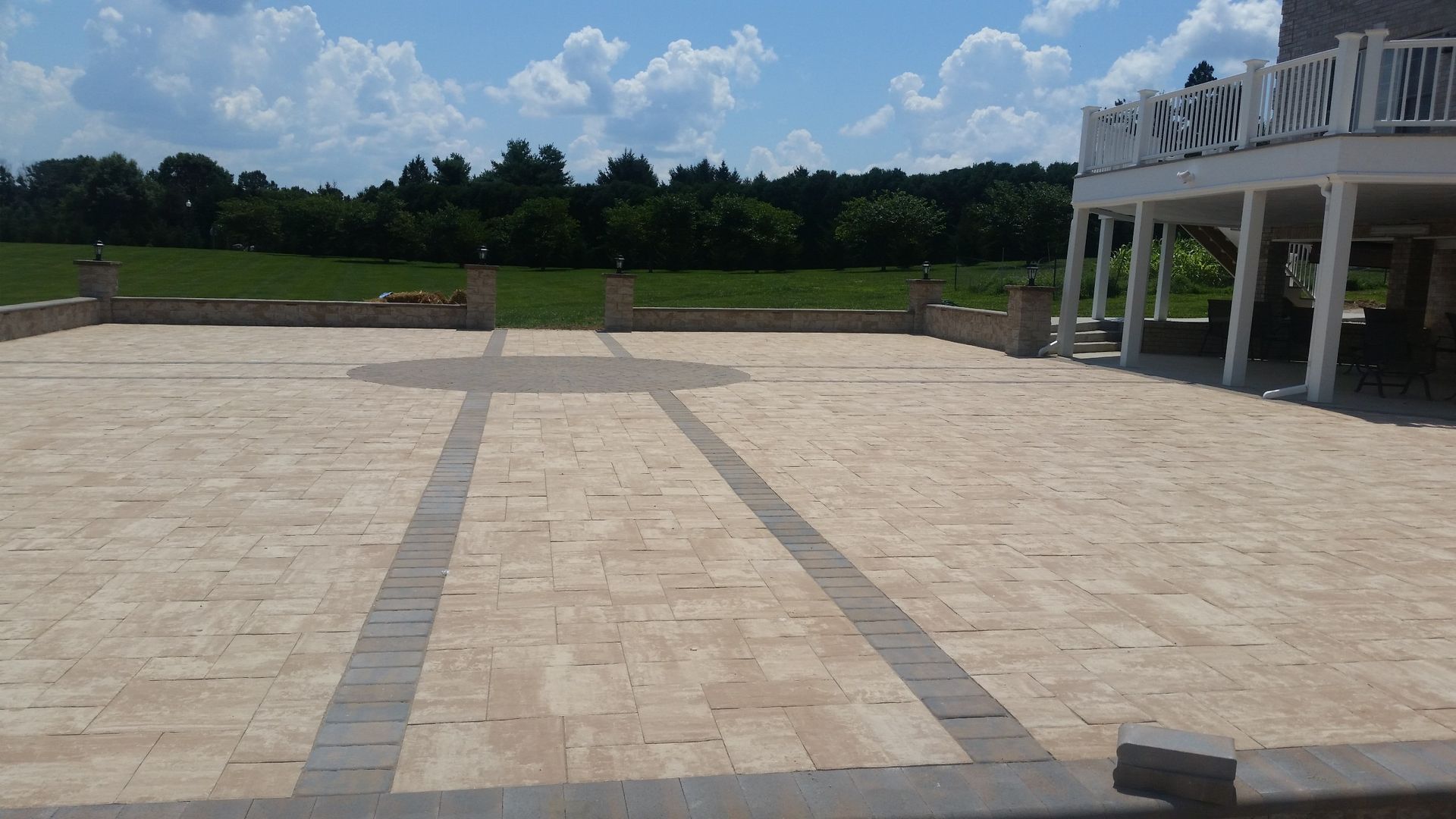 A large patio with a white deck in the background