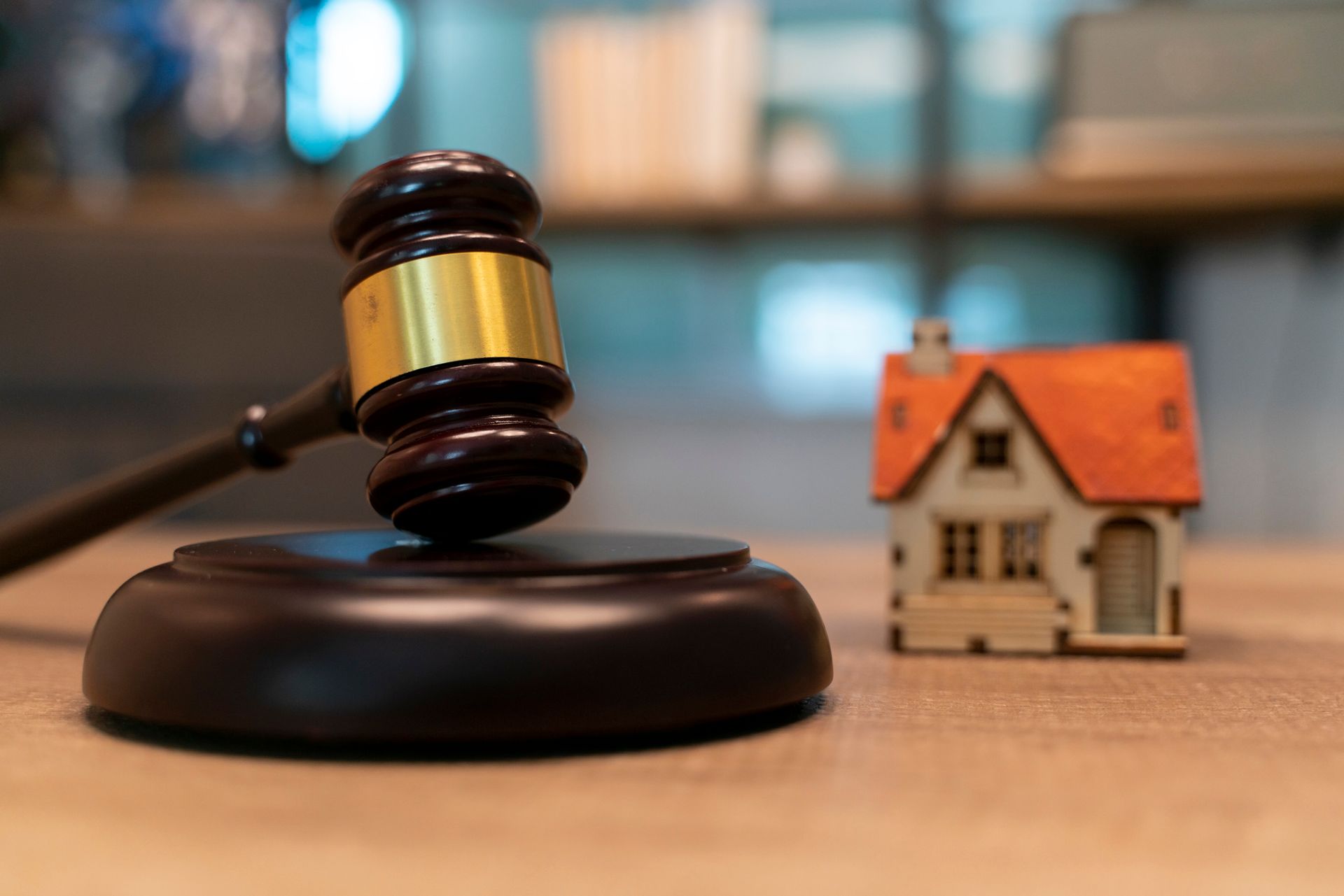 Gavel with small house model, symbolizing estate planning services.