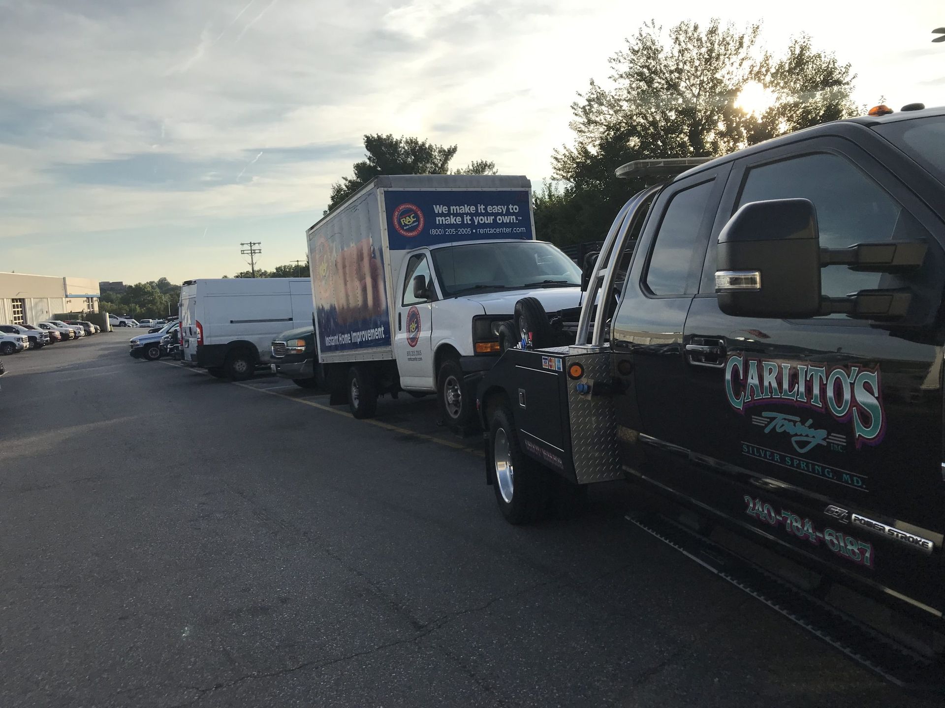 A row of trucks are parked on the side of the road.