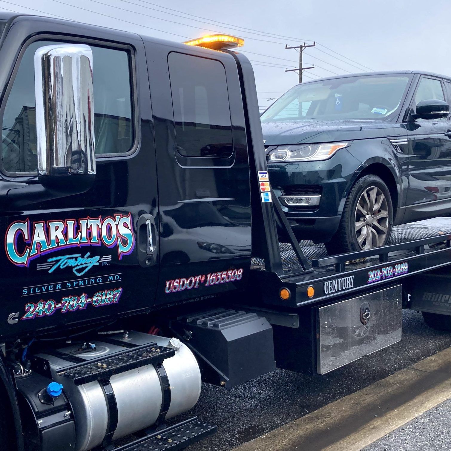 A car is being towed by a tow truck.