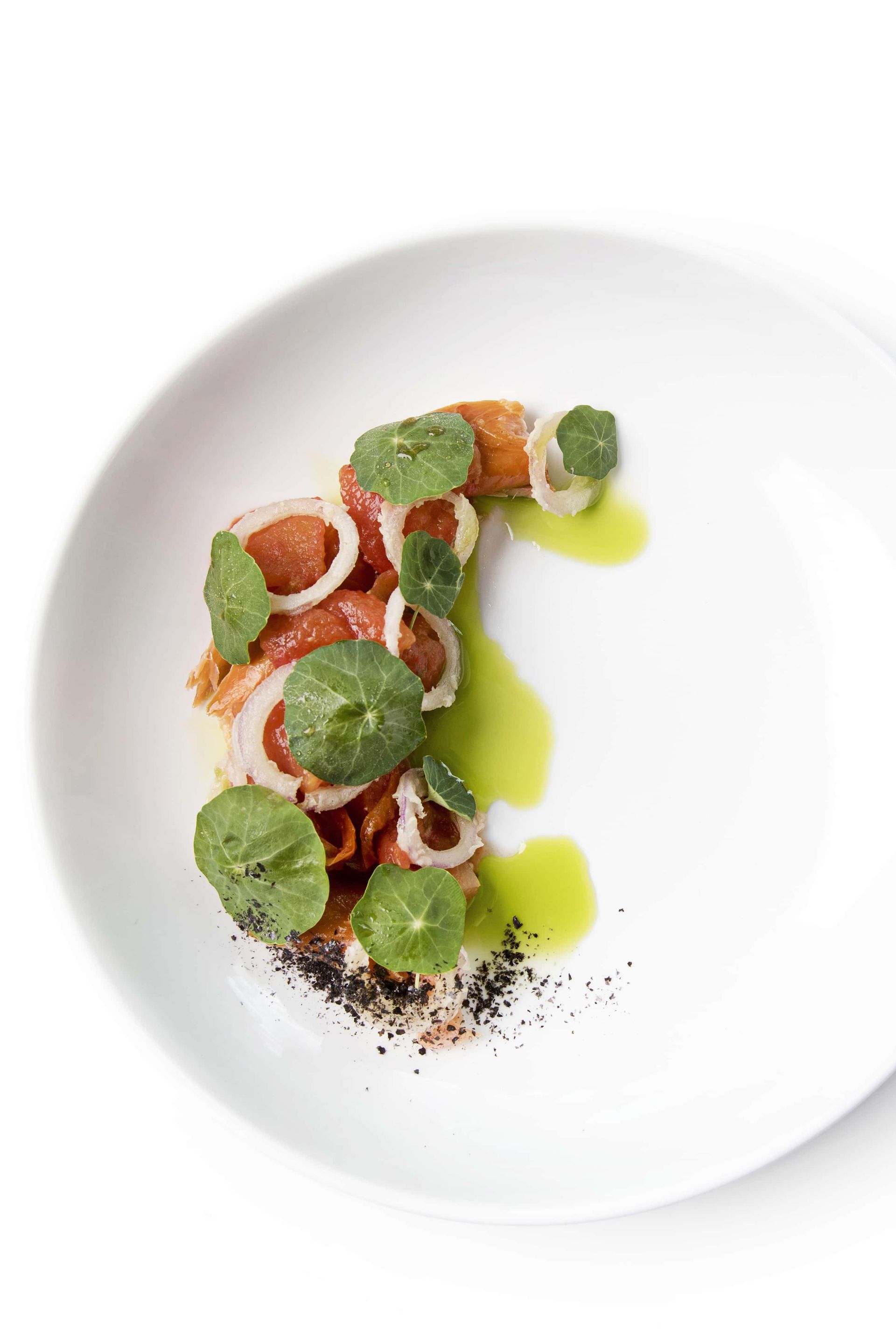 A white plate topped with a plate of food on a white background.