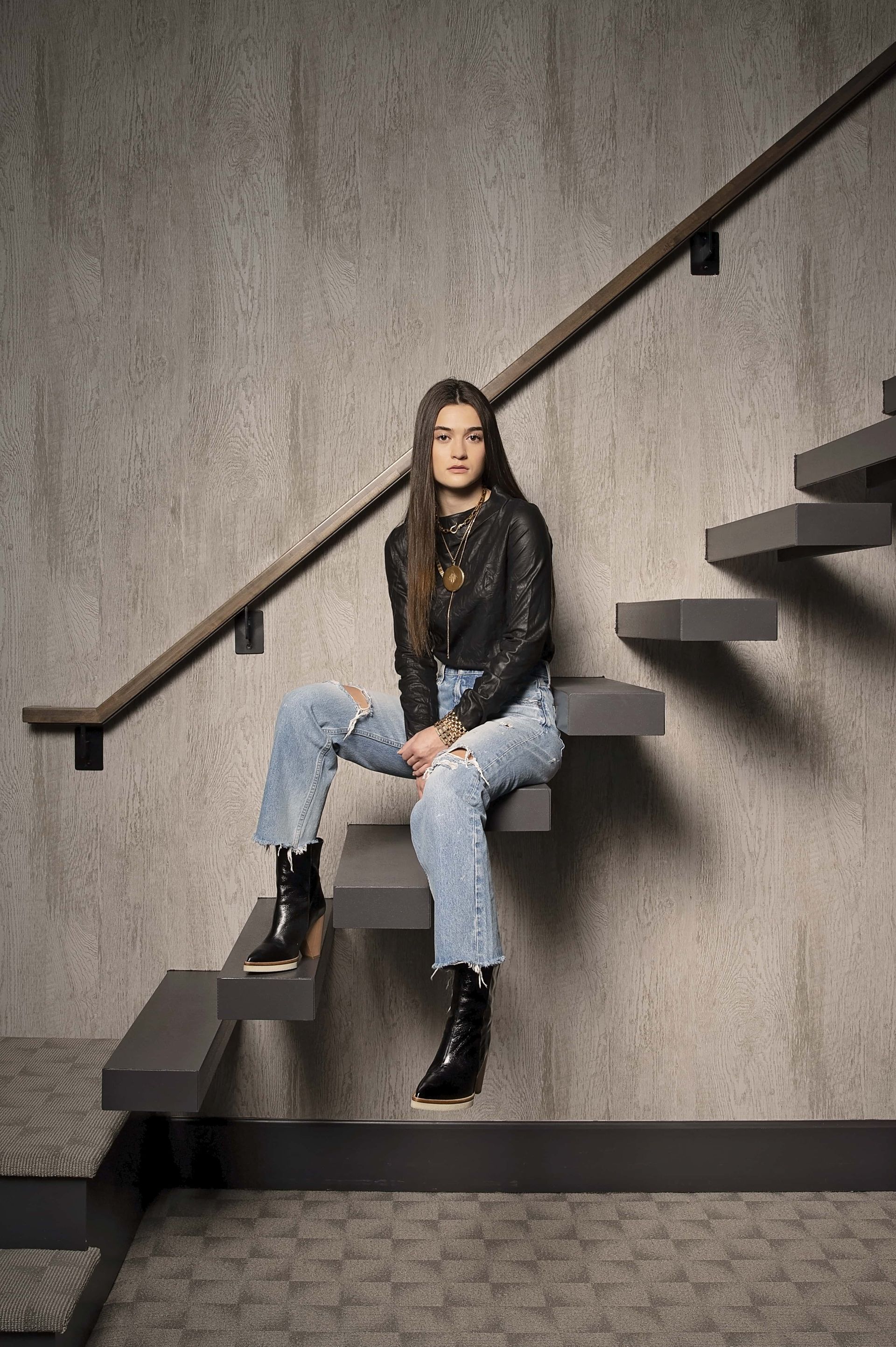 A woman is sitting on a set of stairs.