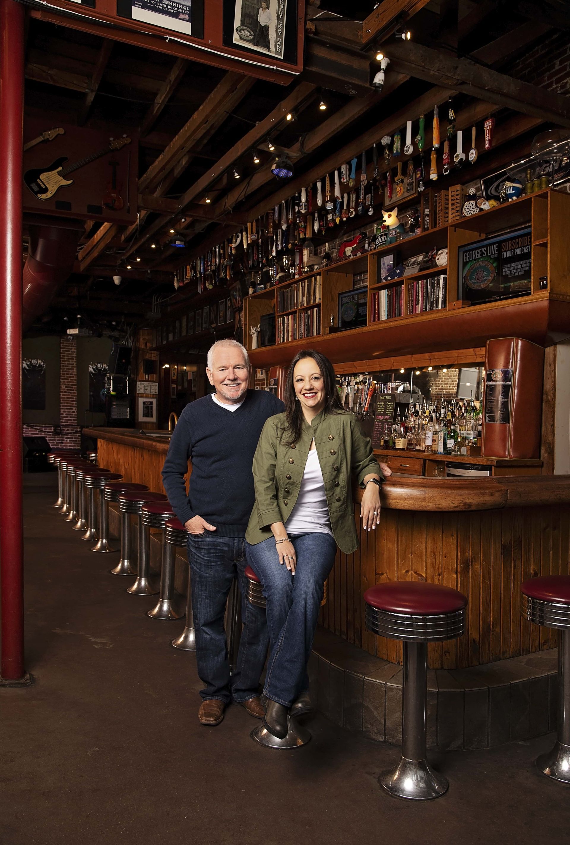 A man and a woman are sitting at a bar.