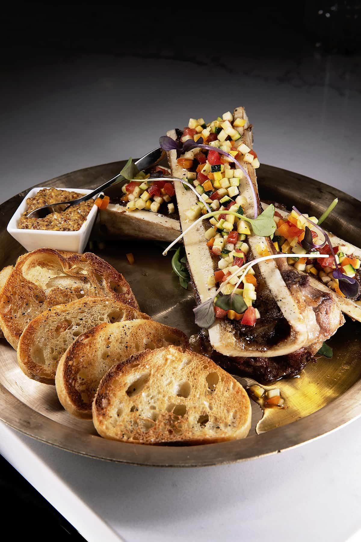 A plate of food with bread and vegetables on a table.