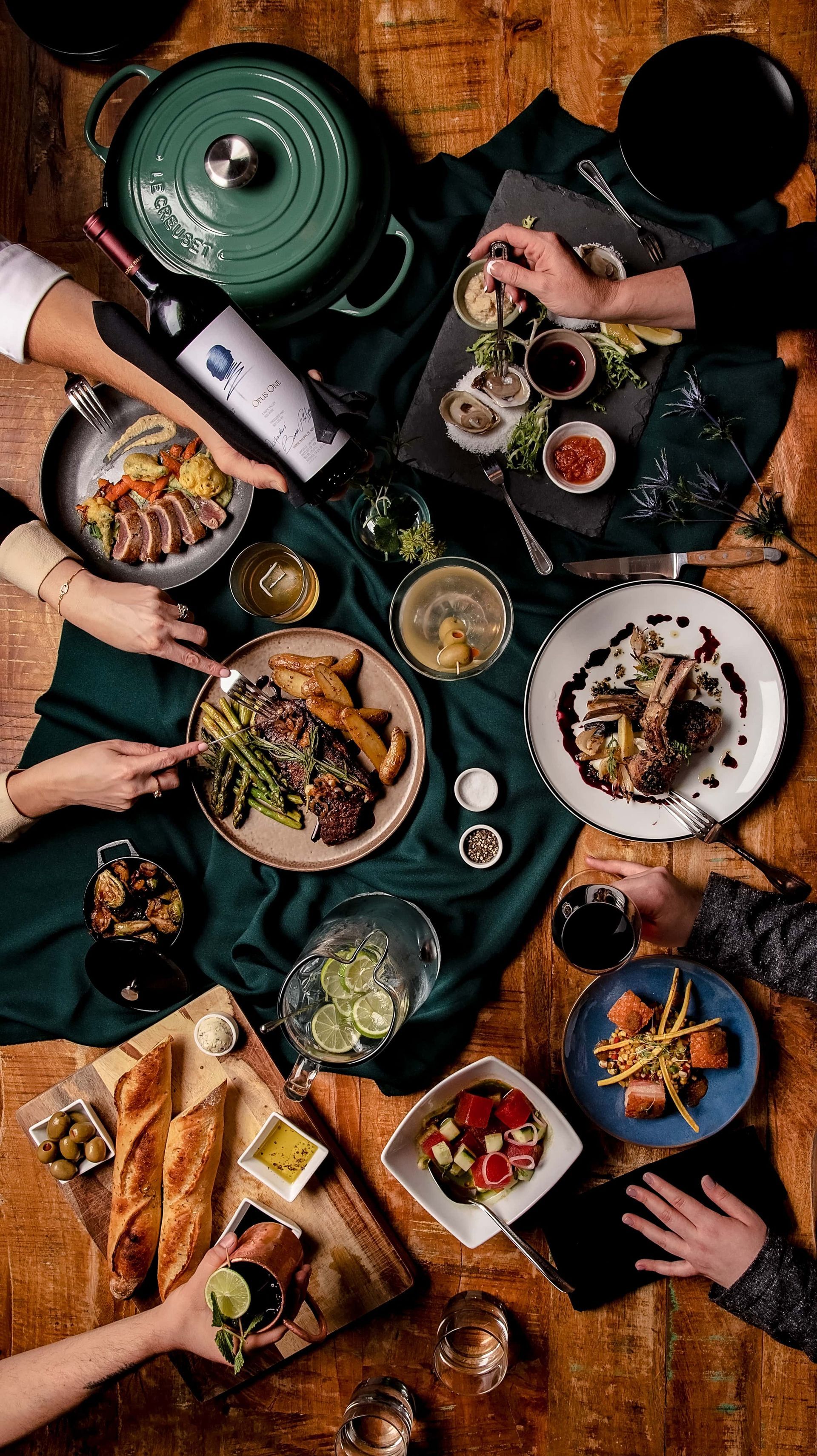 A group of people are sitting around a table eating food.