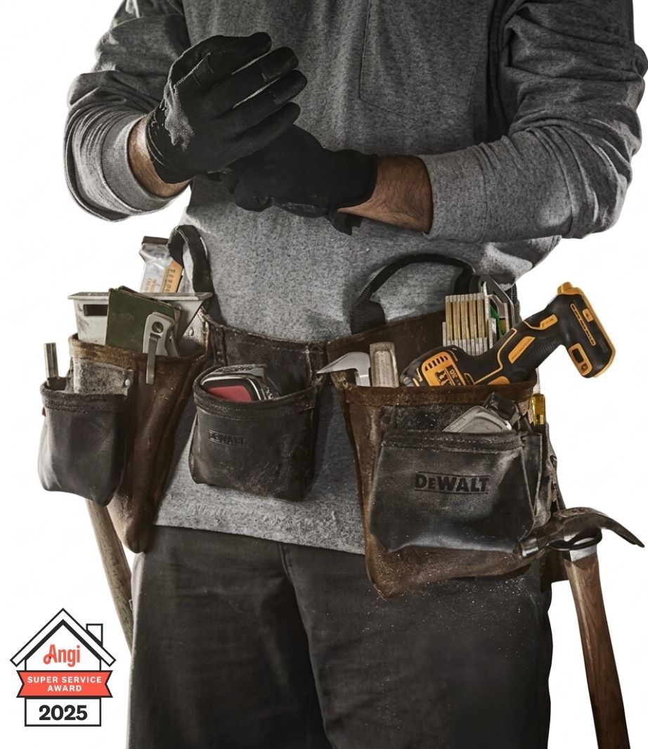 A construction worker wearing a leather tool belt filled with various tools, including a drill, against a white background.