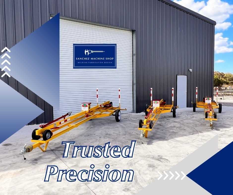 Three yellow rolling straight edges in front of a gray building