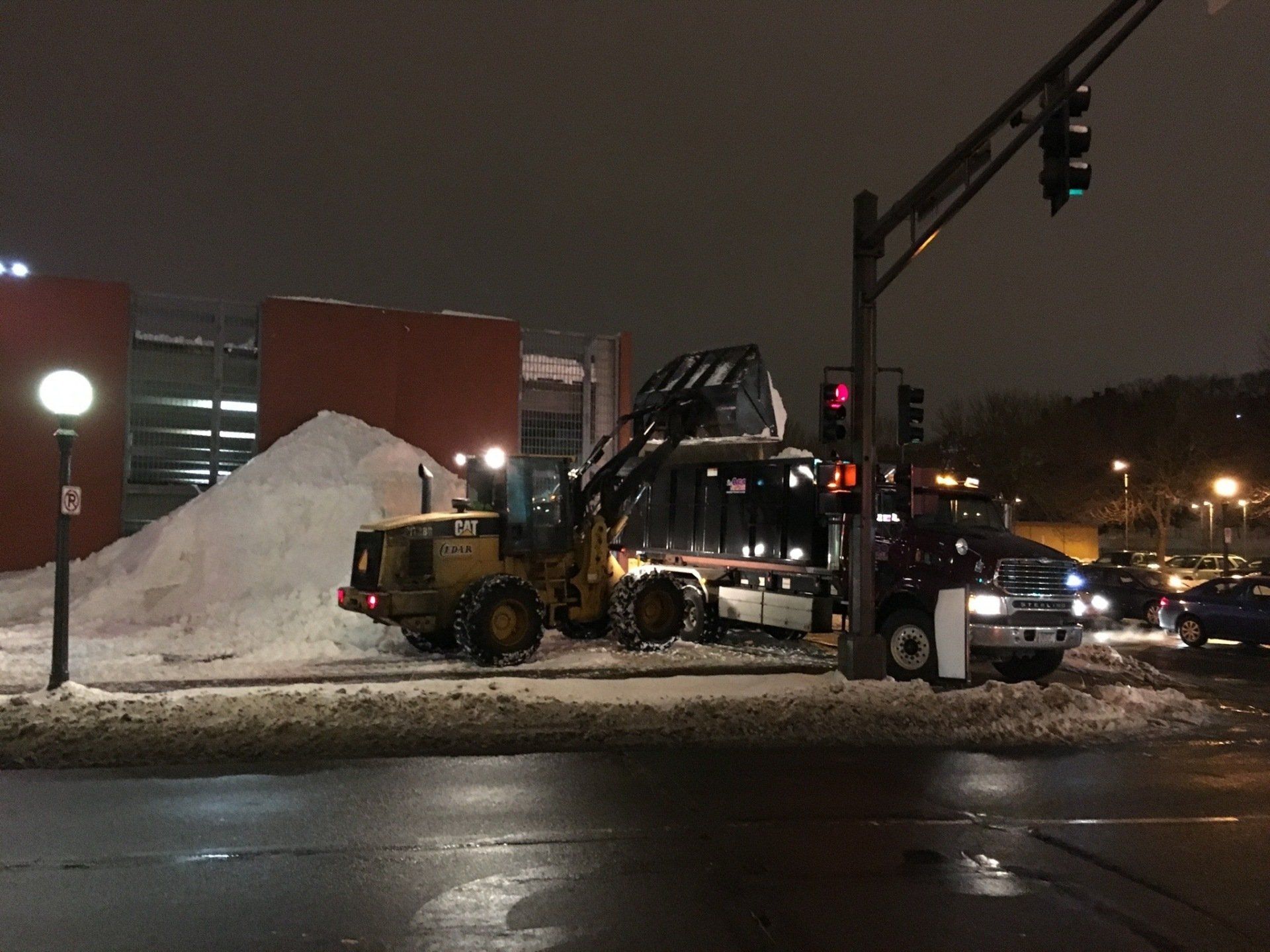Snow hauling at sidewalk during night