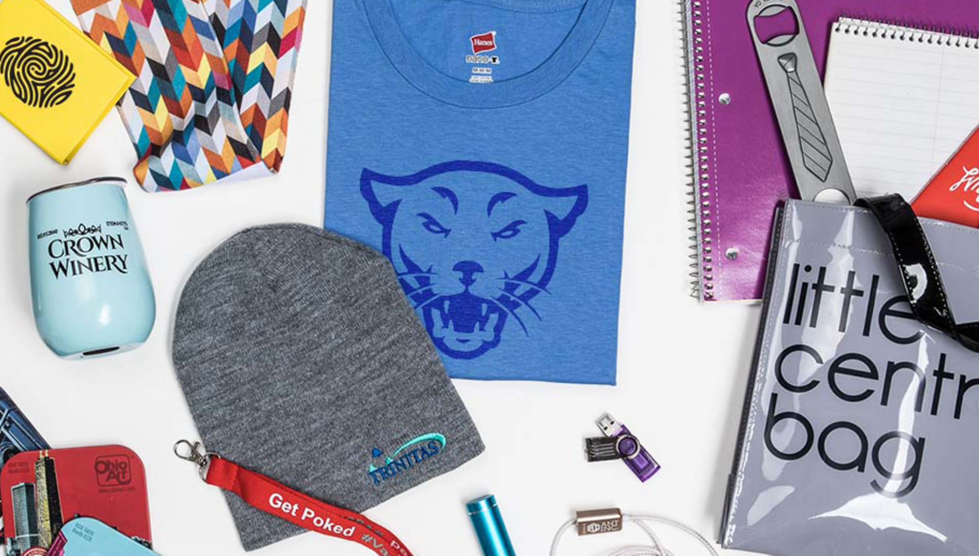 A table topped with a variety of items including a t-shirt and a hat