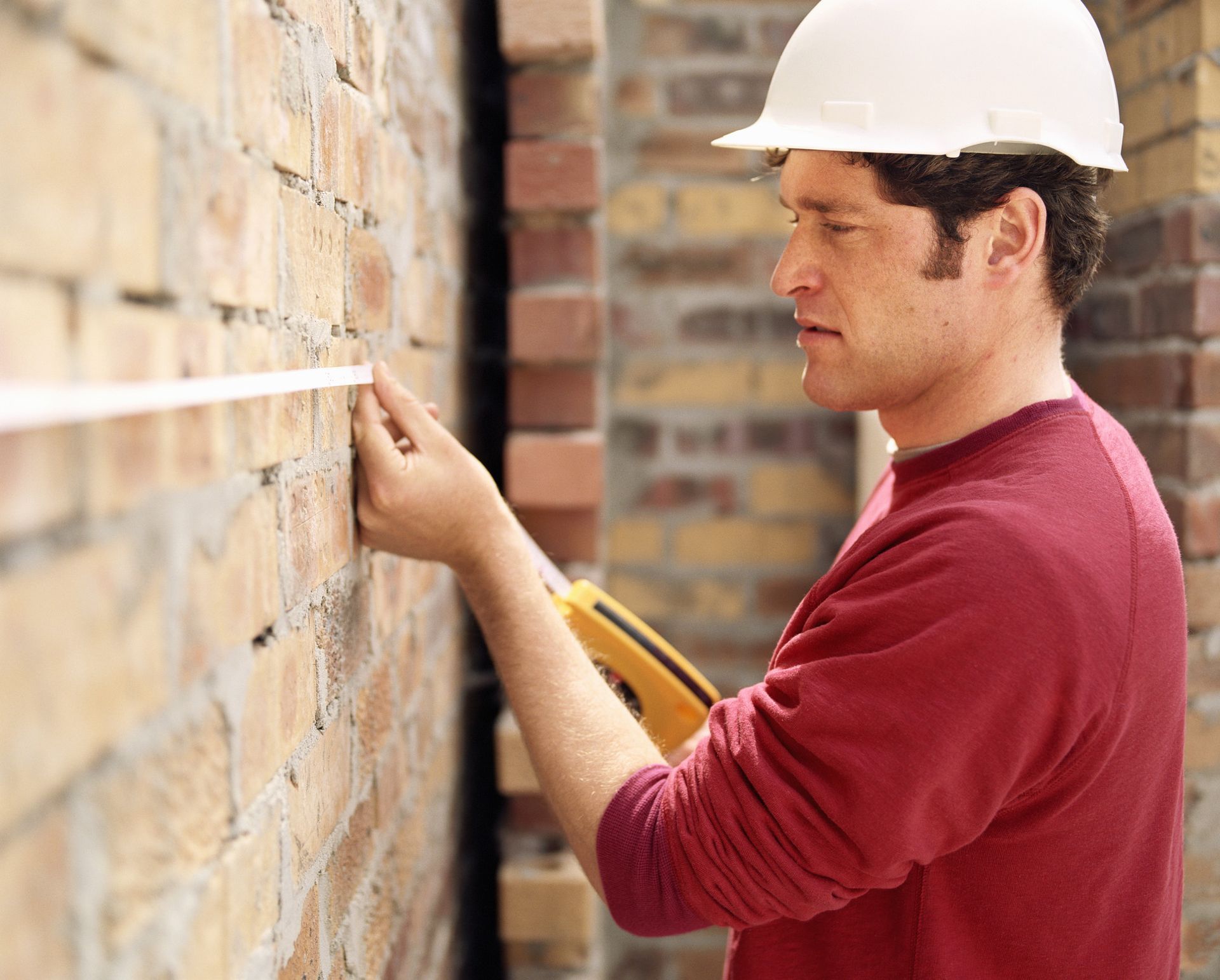 Surveyor checking wall