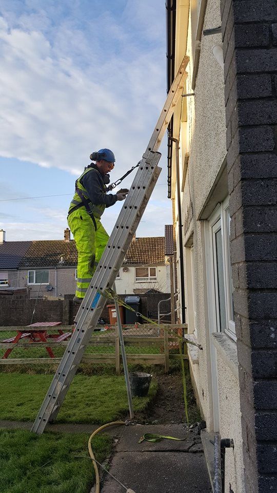 operative up a ladder against a house