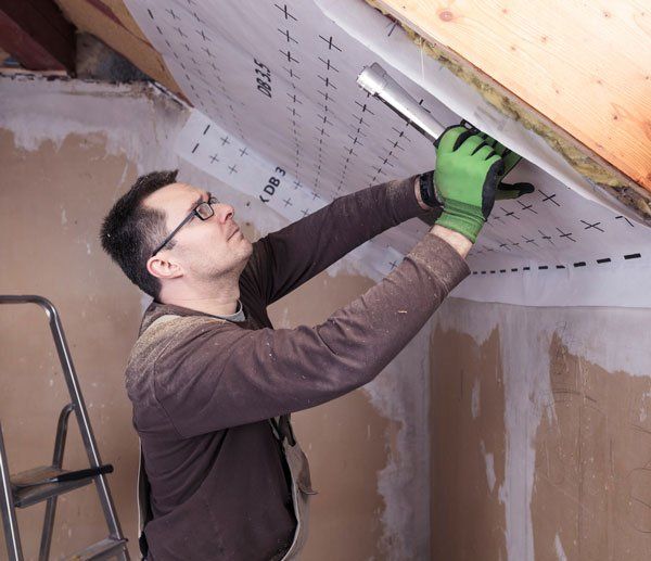 Roof insulation, worker fixing sarking membrane