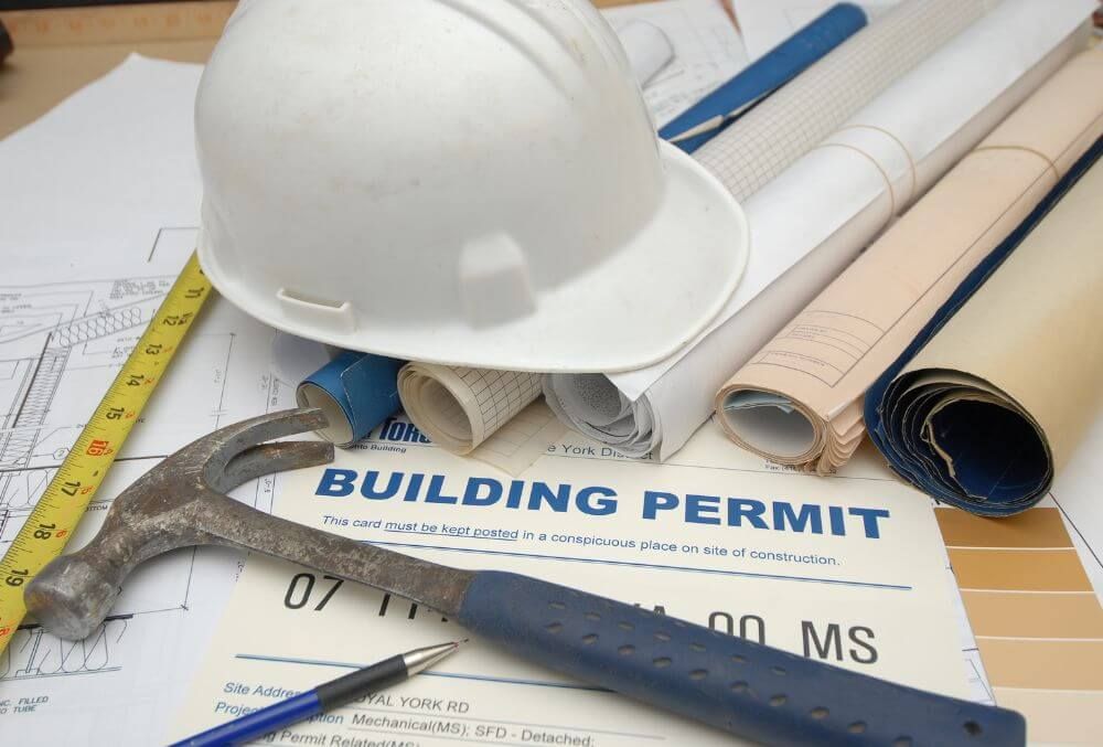 Building permit with tools and plan